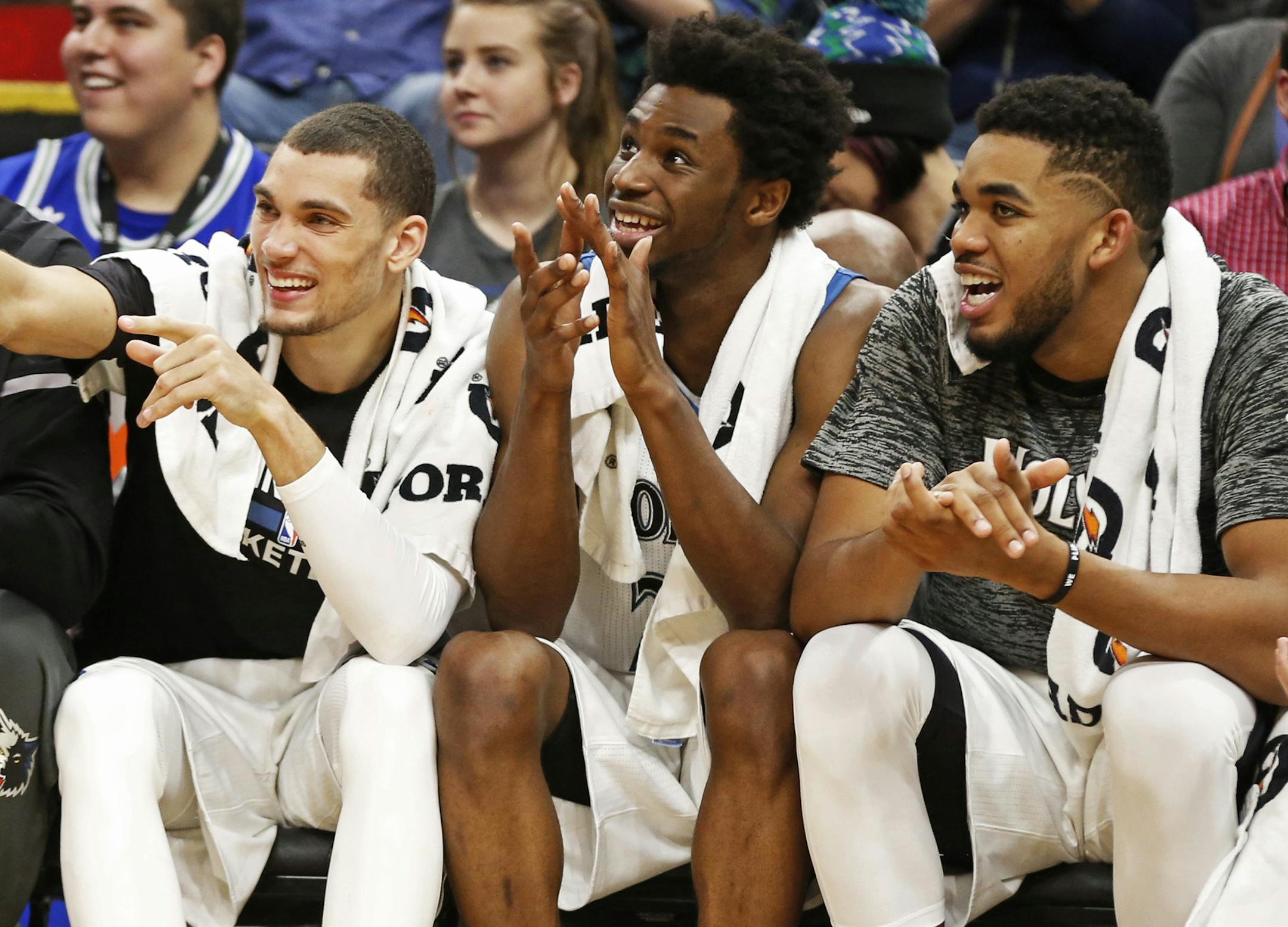 Minnesota Timberwolves' Zach LaVine, left, Andrew Wiggins, center and Karl-Anthony Towns watch the team's NBA basketball game against the Memphis Grizzlies on Tuesday, Nov. 1, 2016, in Minneapolis. The Timberwolves won 116-80. (AP Photo/Jim Mone)