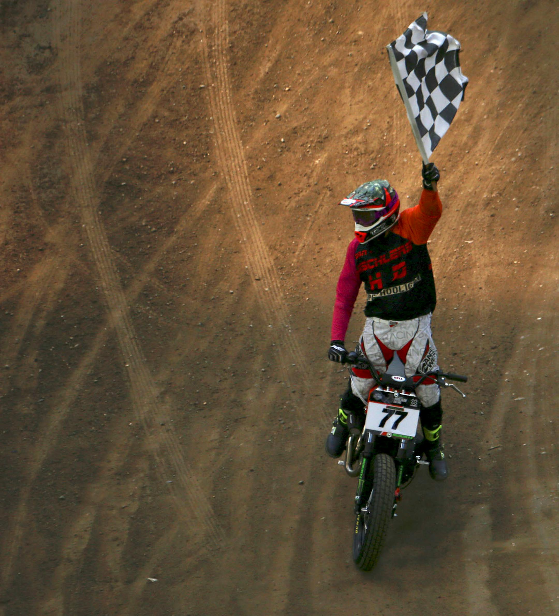 Daniel Mischler raised the checkered flag during his victory lap after winning the final race of Hooligan Racing.