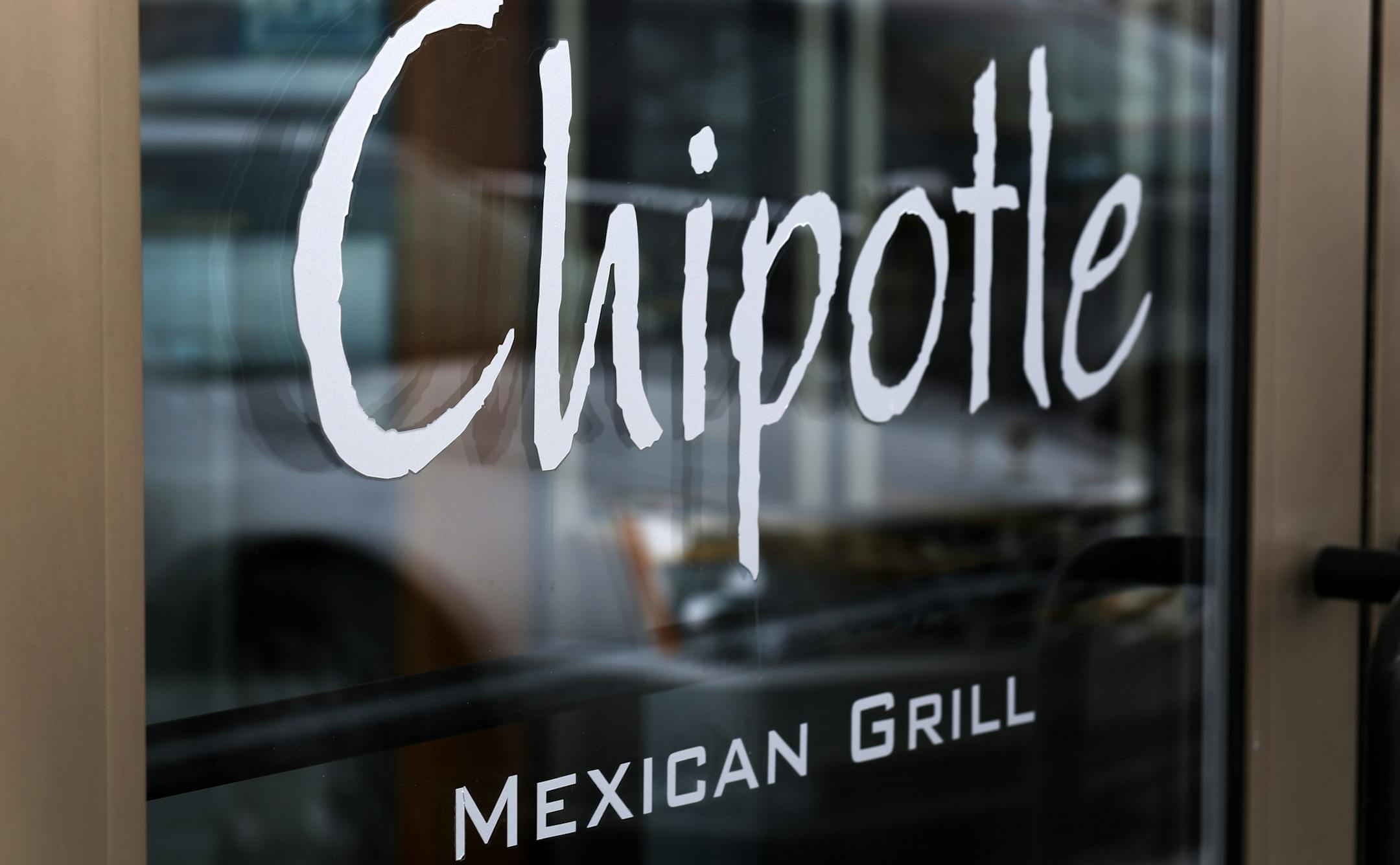 This Tuesday, Jan. 28, 2014, photo, shows the door on a Chipotle Mexican Grill in Robinson Township, Pa. Chipotle reports quarterly earnings on Thursday, Jan. 30, 2014. (AP Photo/Gene J. Puskar)