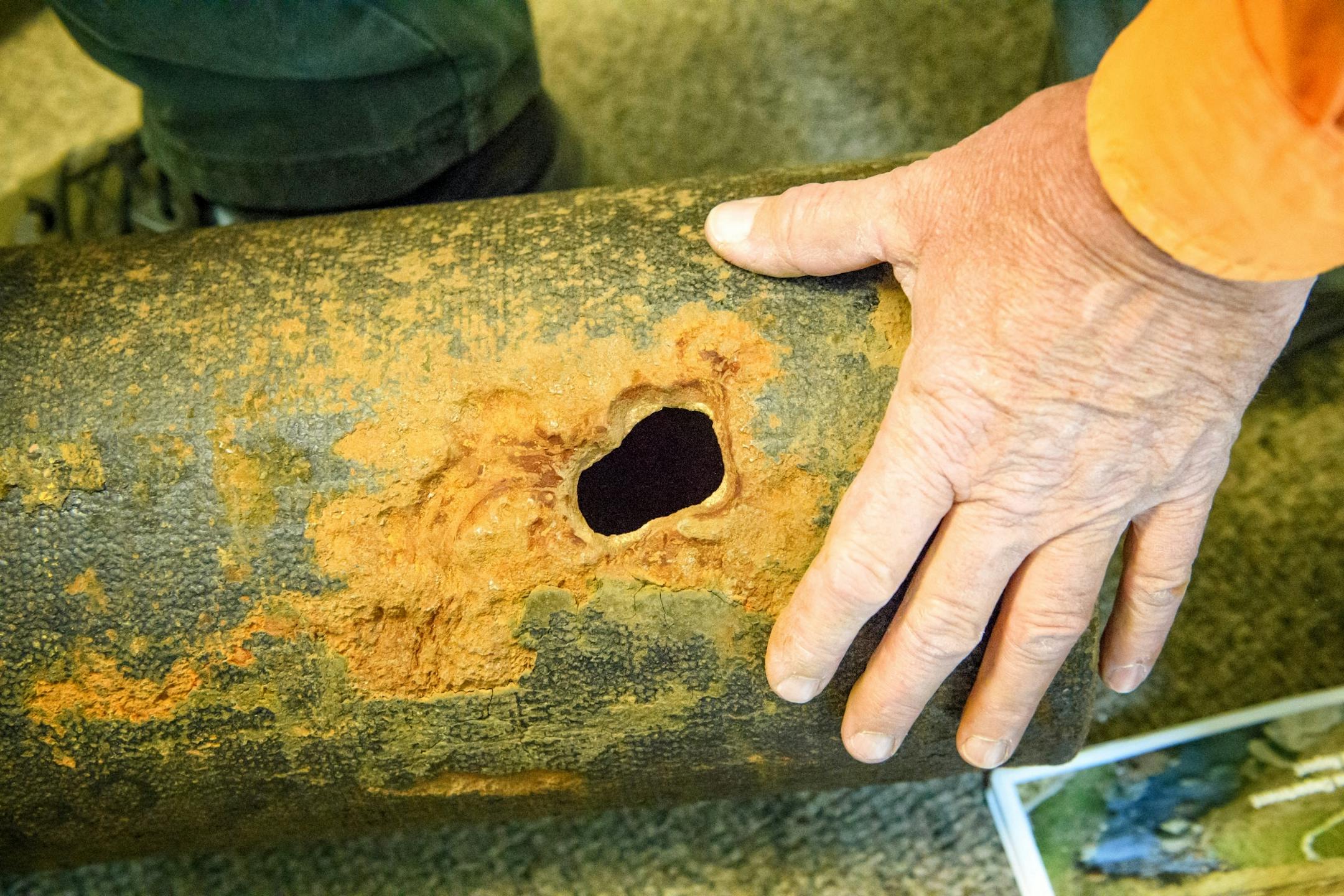 Daniel Berg, utility operations supervisor held examples of underground fresh water pipes damaged by electrolysis in Duluth.