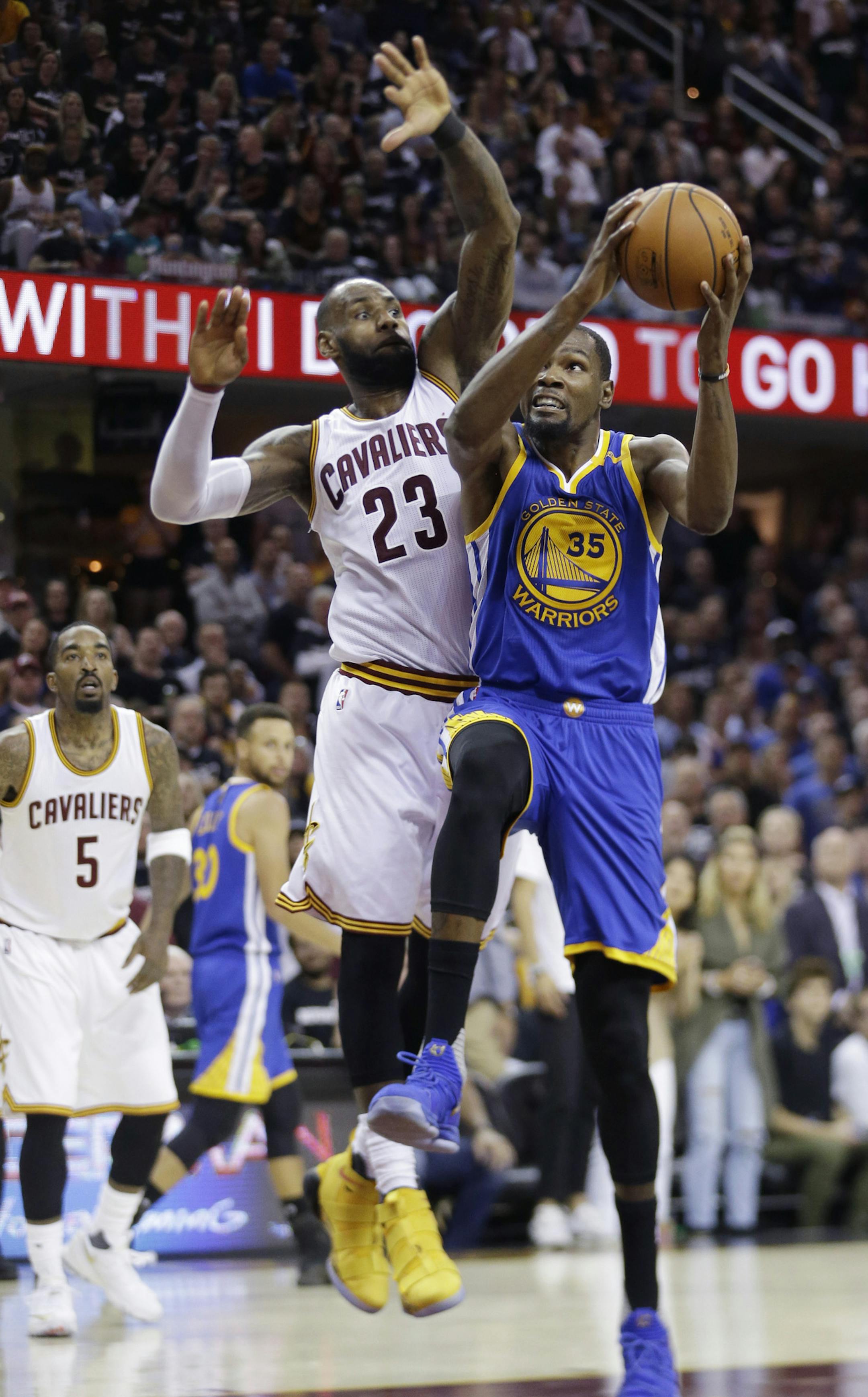 Golden State Warriors forward Kevin Durant (35) drives on Cleveland Cavaliers forward LeBron James (23) during the second half of Game 4 of basketball's NBA Finals in Cleveland, Friday, June 9, 2017. (AP Photo/Tony Dejak)