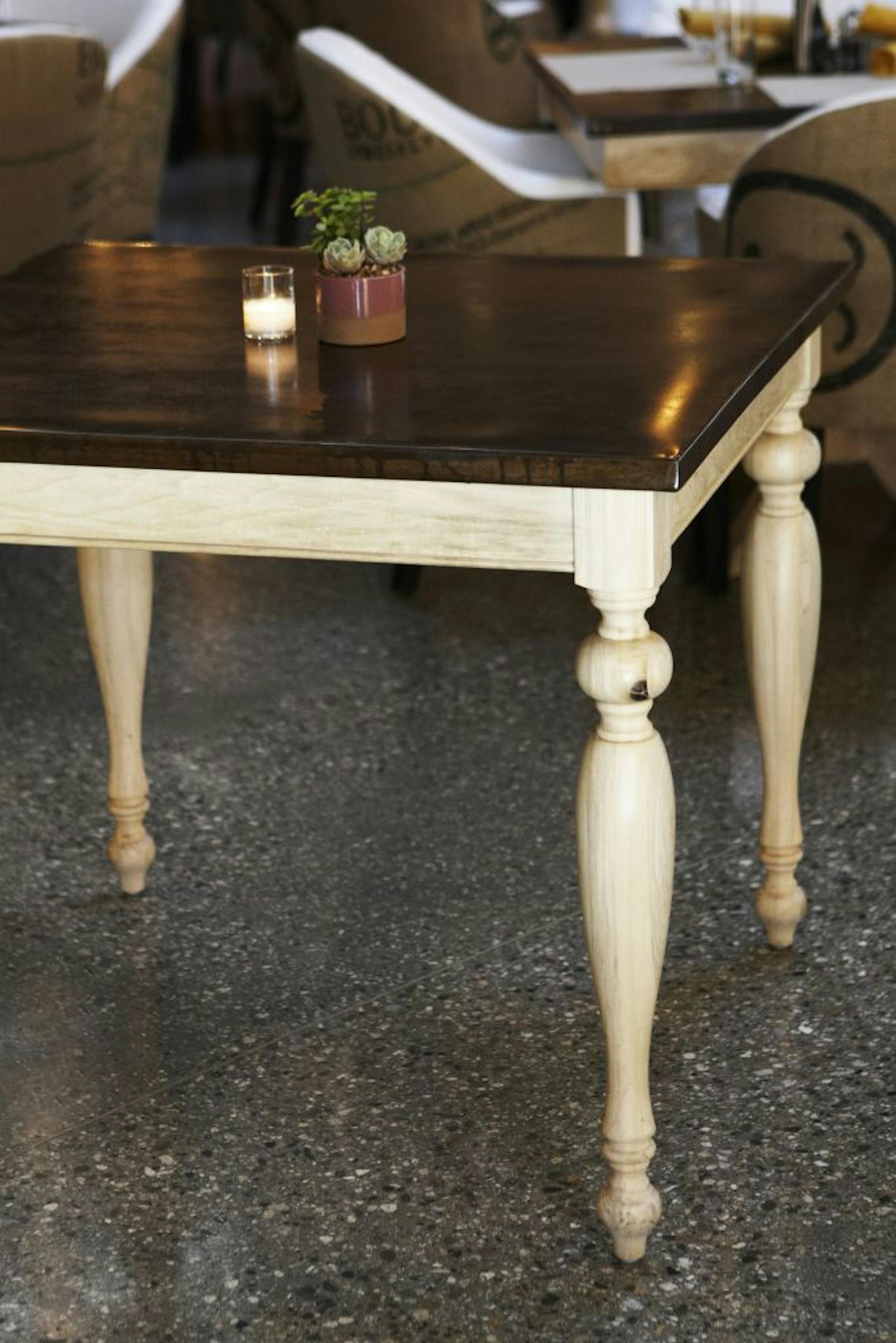 Square dining room table with wooden base and metal top ($525).