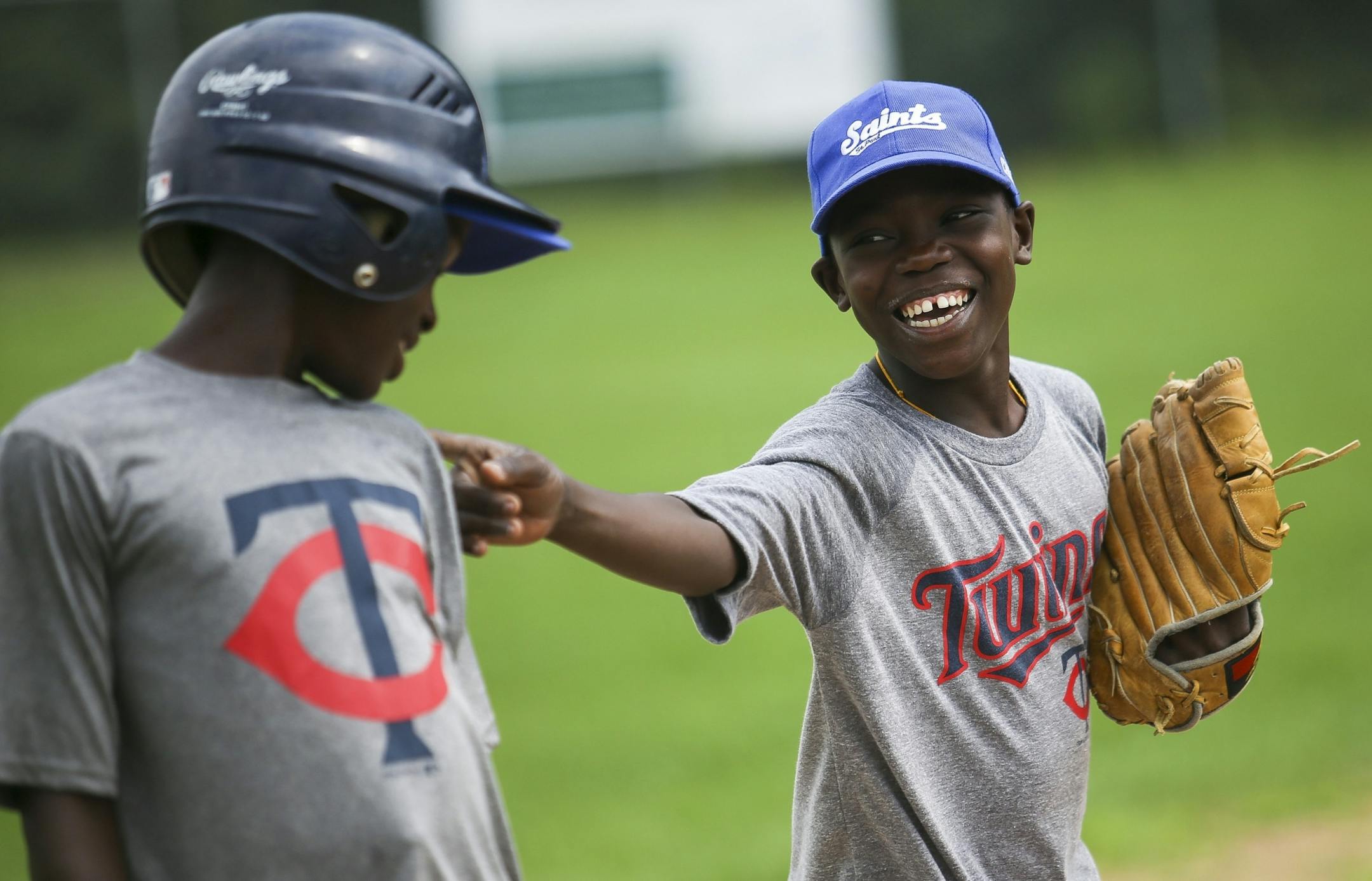 Enock Fambo, right, jokes with Thomas Agbo after tagging out Agbo during a morning practice at Lakeview Terrace Park on Tuesday, August 2, 2016 in Robbinsdale.