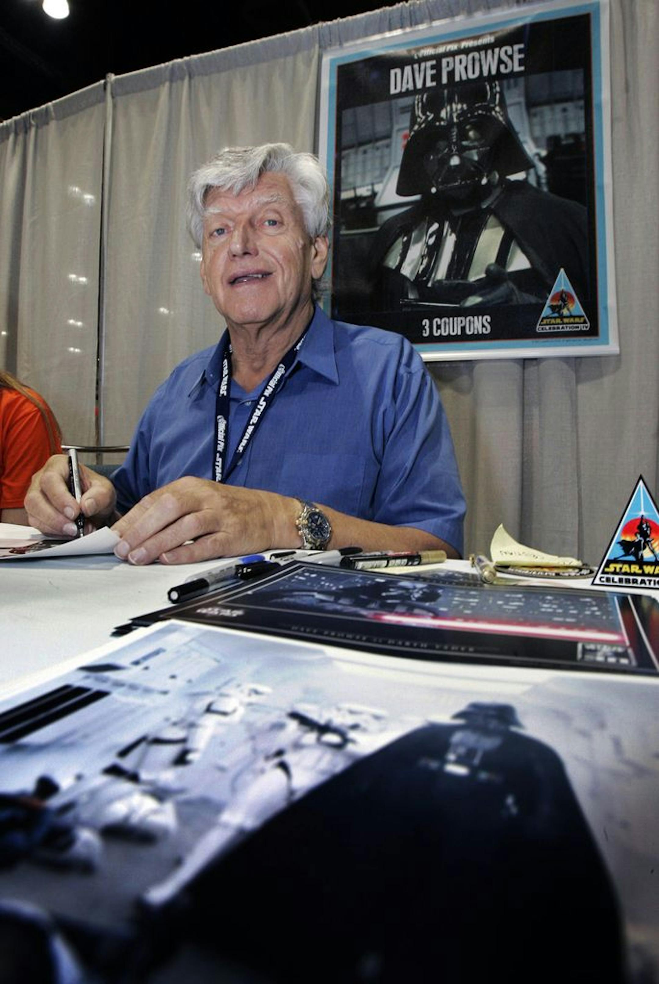 FILE - In this file photo dated Saturday, May 26, 2007, actor David Prowse, who was the man in the black Darth Vader suit in the first Star Wars film, signs autographs at Star Wars Celebration IV, marking the 30th anniversary of the release of the first film in the Star Wars saga, in Los Angeles, USA. The British actor, Prowse who played Darth Vader in the original Star Wars trilogy, has died aged 85 on Saturday, according to an announcement by his agent Sunday Nov. 29, 2020.