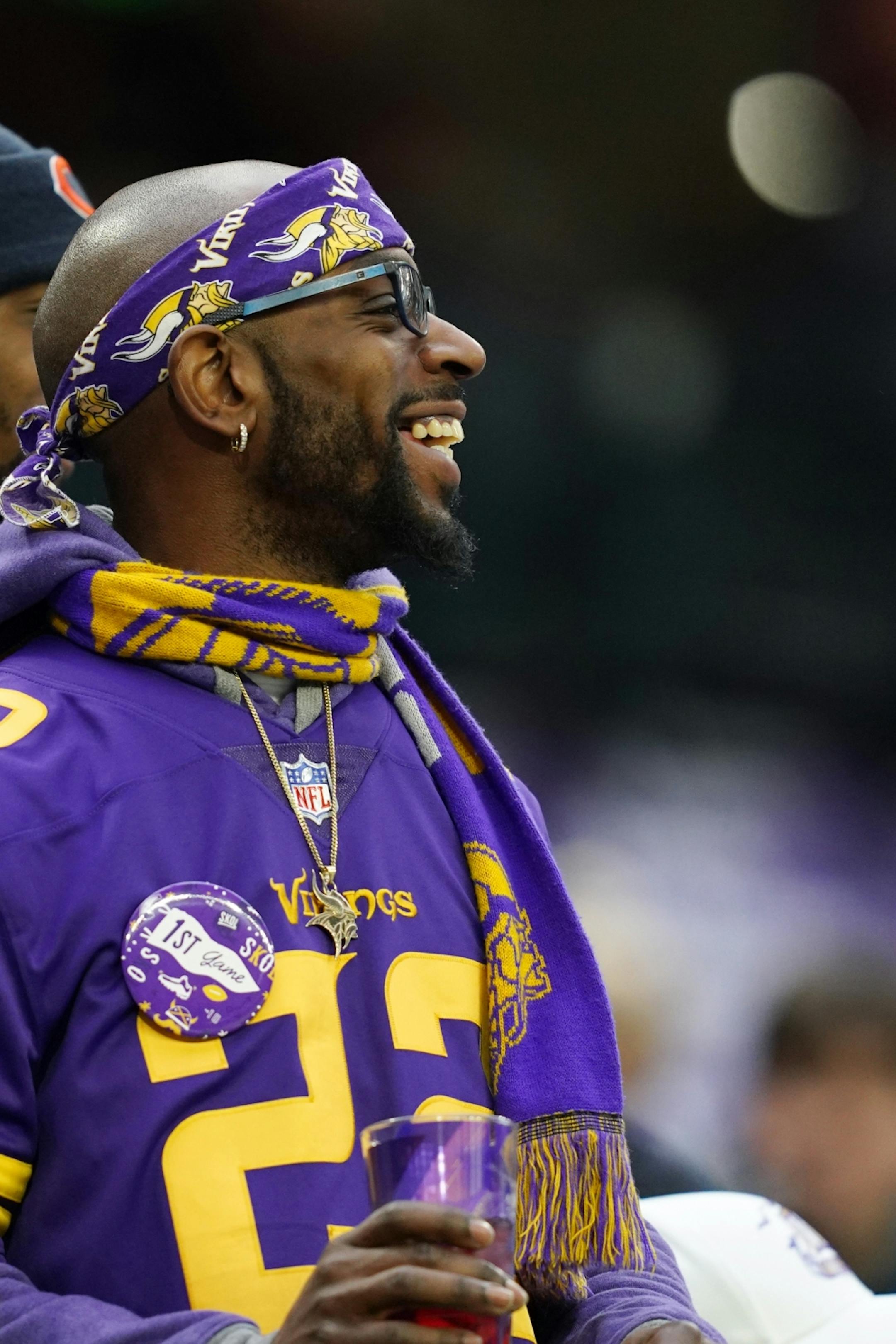 A Minnesota Vikings wearing a first game pin watched as the players warmed up on the field ahead of Sunday's game against the Chicago Bears.