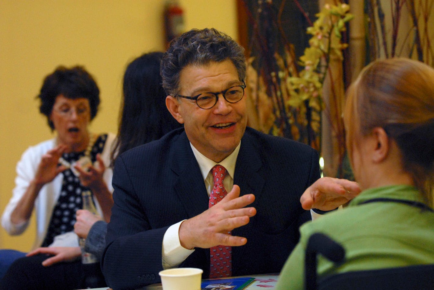 U.S. Senate candidate Al Franken spoke to DFL convention delegate Kelsey Neumann at a coffee shop gathering Wednesday in St. Paul.