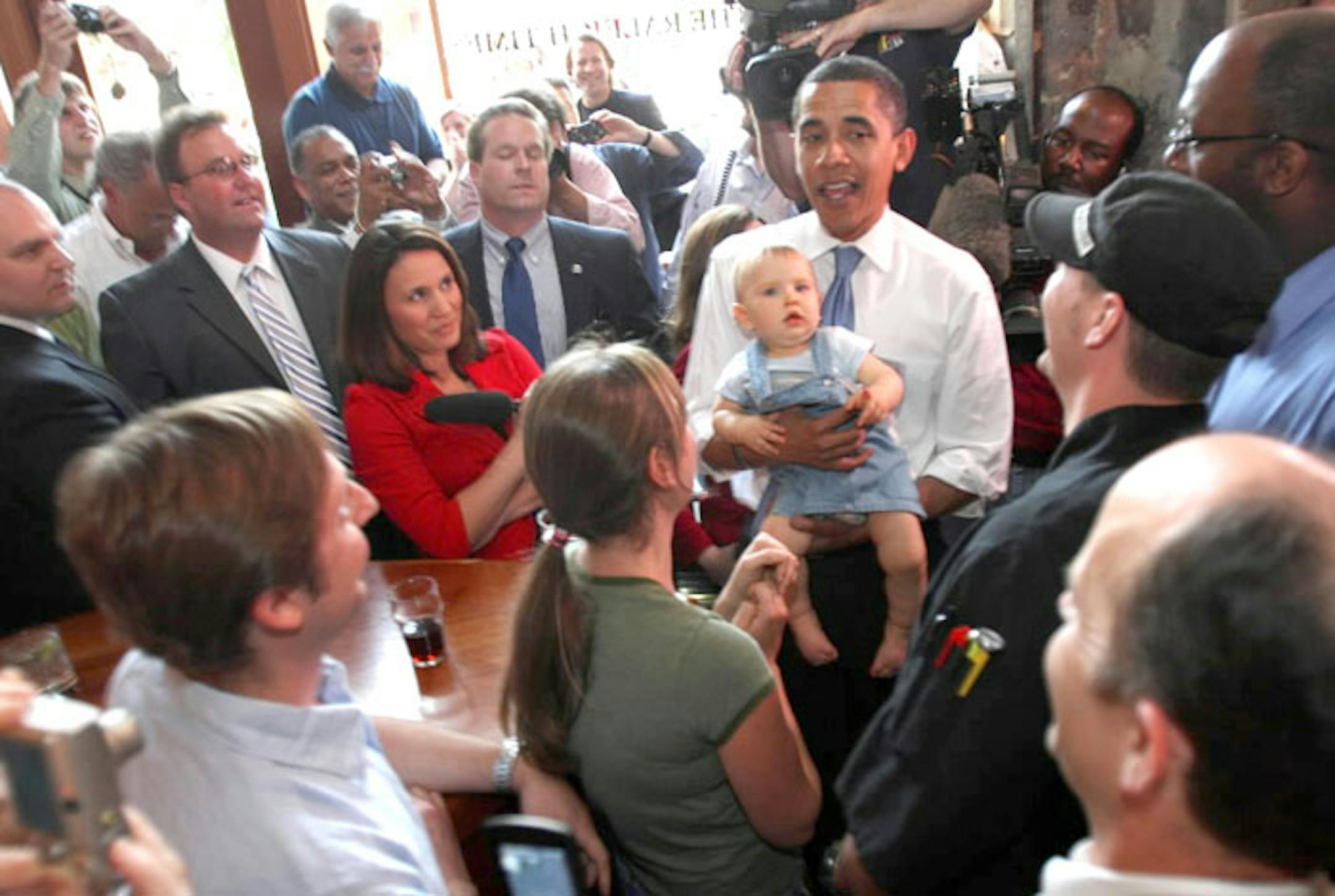 Barack Obama holds 9-month-old Justin Spitzer during a visit to the Raleigh Times Bar in Raleigh, N.C., Tuesday.
