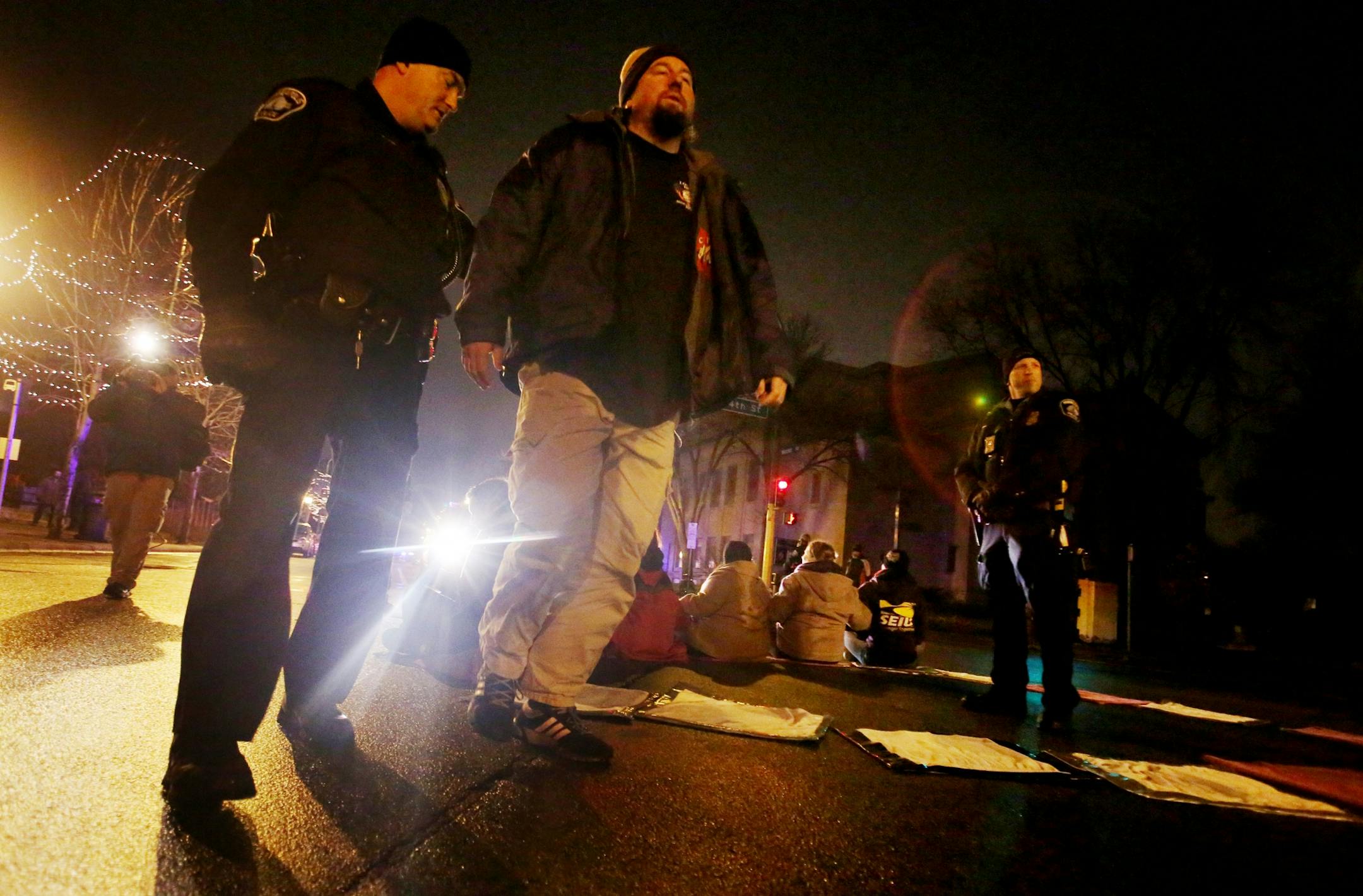 Protestors for Nationwide Fight for $15 Day of Disruption gathered outside McDonald's at 24th St. E. and Franklin Avenue, where for about a half hour protestors sat in a circle and blocked the intersection until they were arrested by Minneapolis police Tuesday, Nov. 29, 2016, in Minneapolis, MN. Here, a man is taken into custody after protestors sat and blocked the intersection at 24th St. E. and Franklin Avenue. Those arrested were ticketed and released.