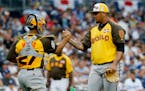 World Team pitcher Adalberto Mejia, of the San Francisco Giants, and catcher Francisco Mejia (27) celebrate their 11-3 win against the U.S. Team after