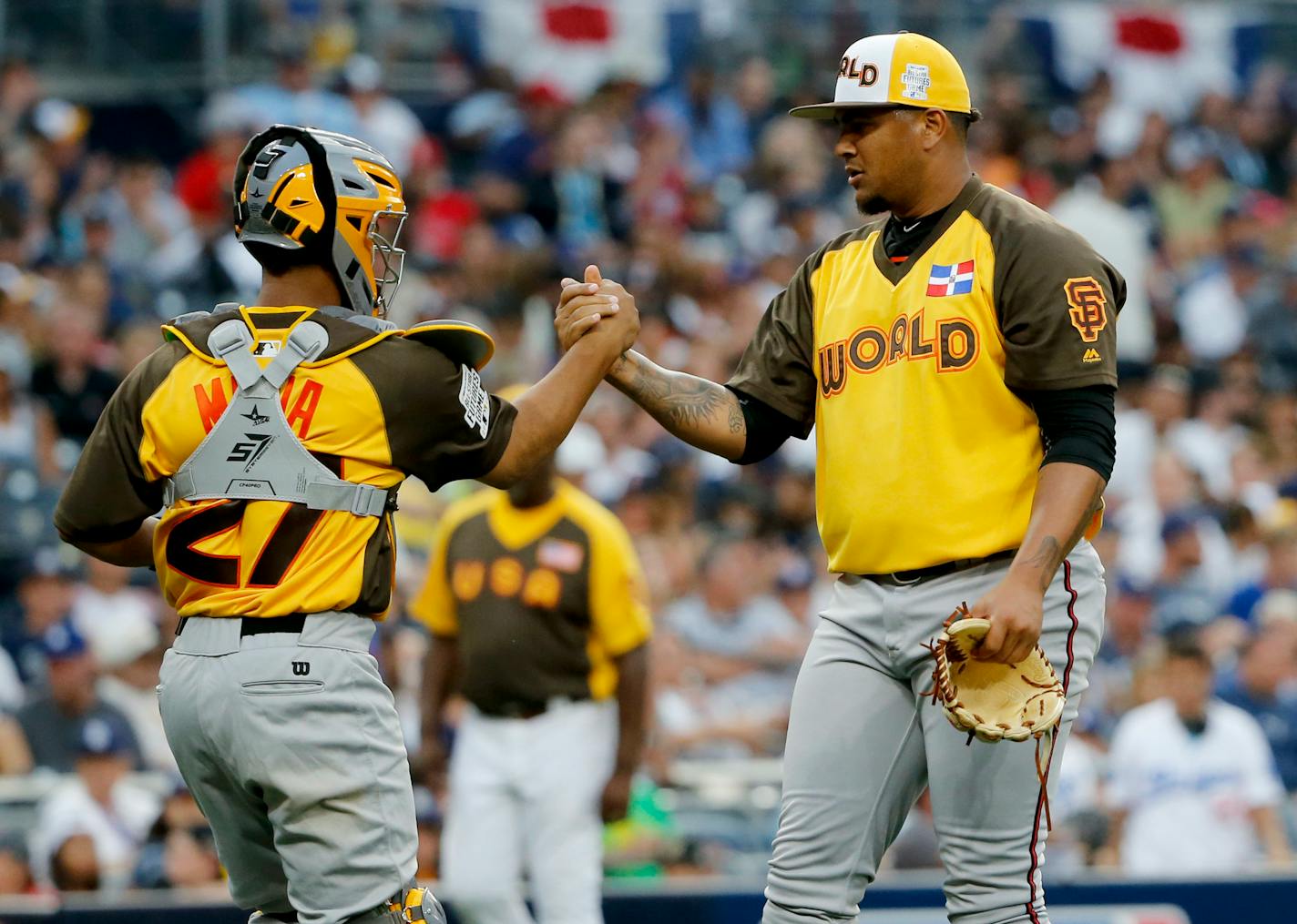 World Team pitcher Adalberto Mejia, of the San Francisco Giants, and catcher Francisco Mejia (27) celebrate their 11-3 win against the U.S. Team after the All-Star Futures baseball game, Sunday, July 10, 2016, in San Diego. (AP Photo/Lenny Ignelzi)