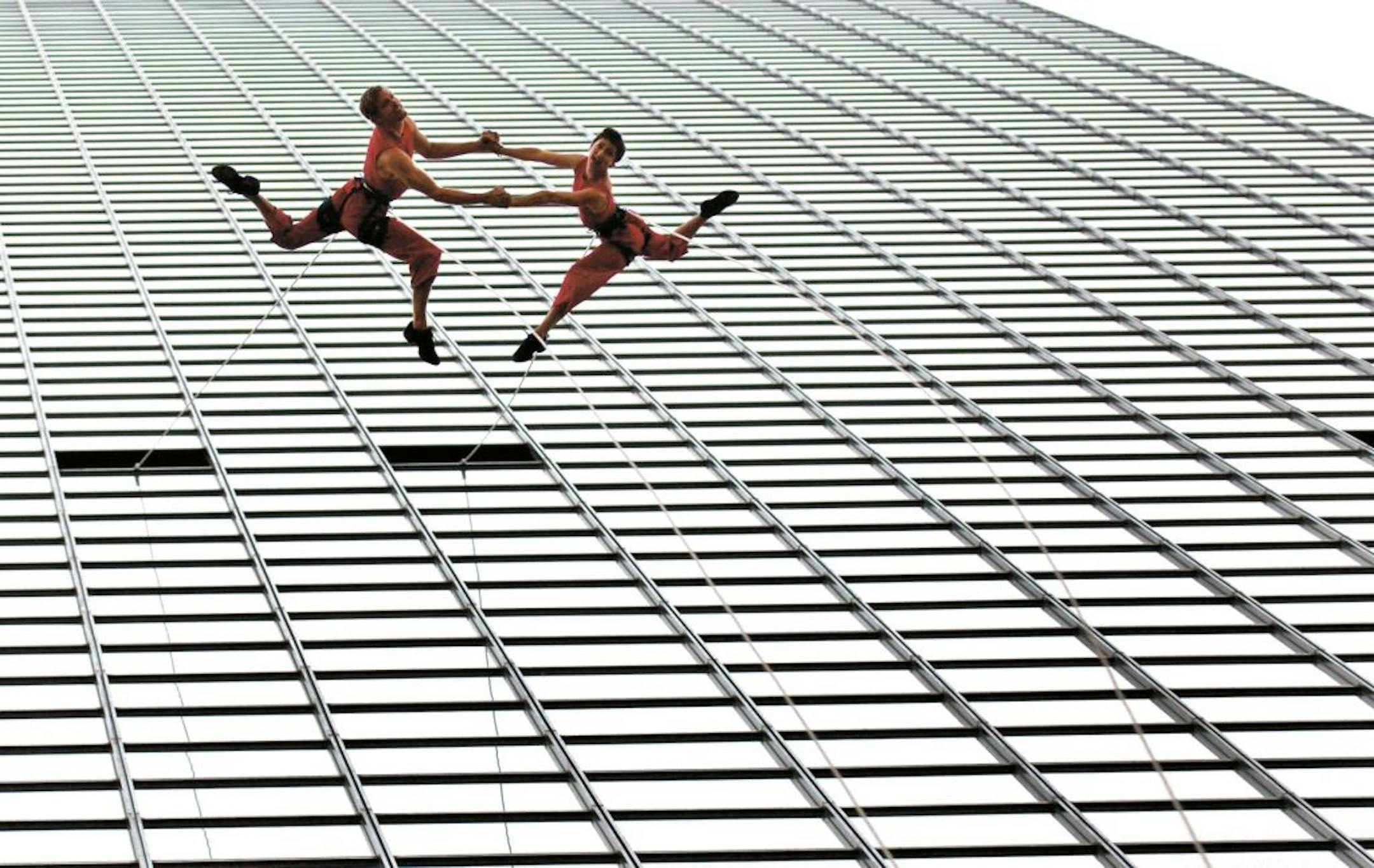 Aerial dancers from Project Bandaloop performed a dance as they rappelled down the side of Thanksgiving Tower in Dallas.