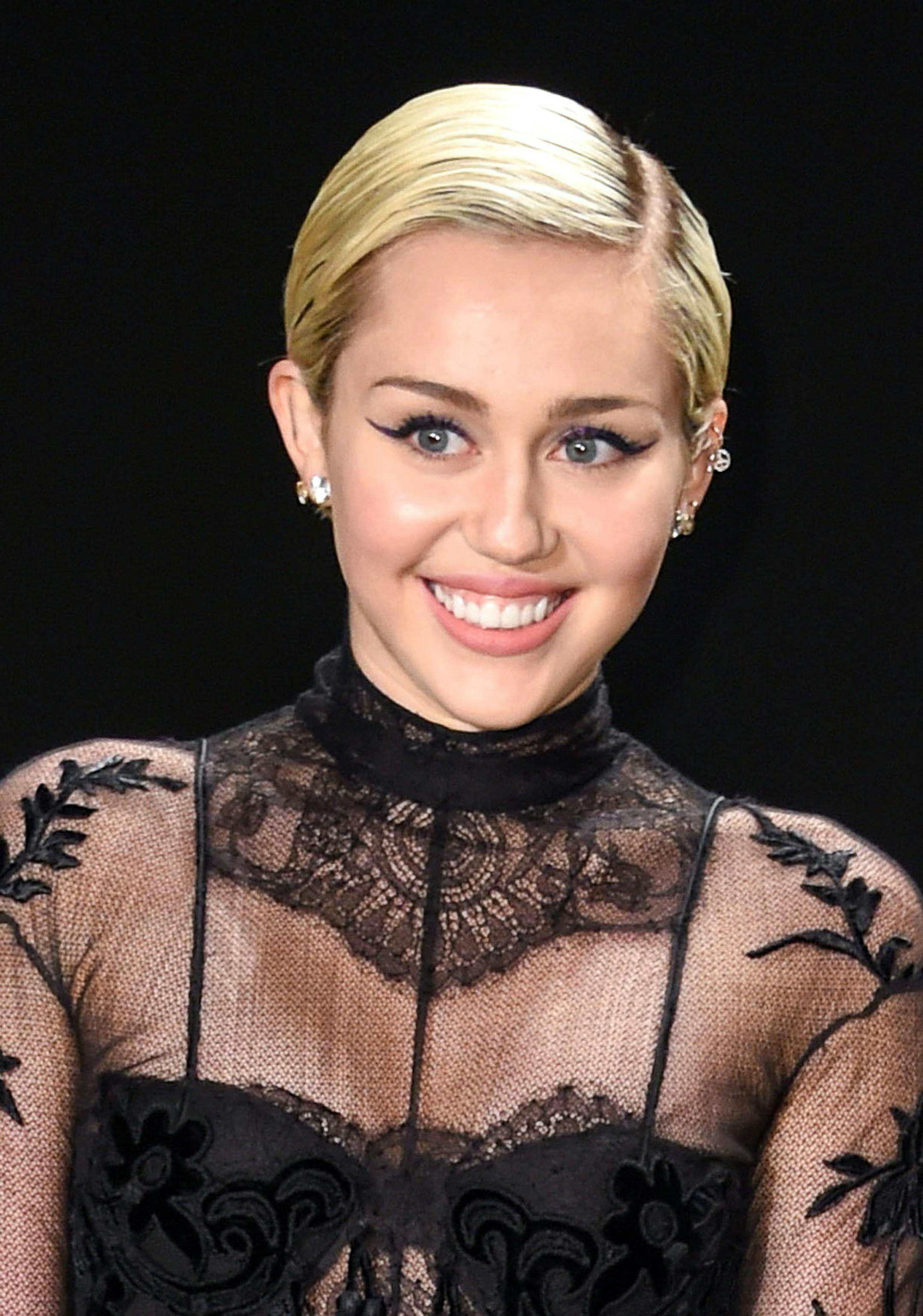 FILE - In this Feb. 20, 2015 file photo, Miley Cyrus arrives at the Tom Ford Autumn/Winter 2015 Womenswear Presentation in Los Angeles. On Oct. 3, Cyrus will return as host for a third time to kick off the 41st season of "Saturday Night Live." (Photo by Rob Latour/Invision/AP, File)