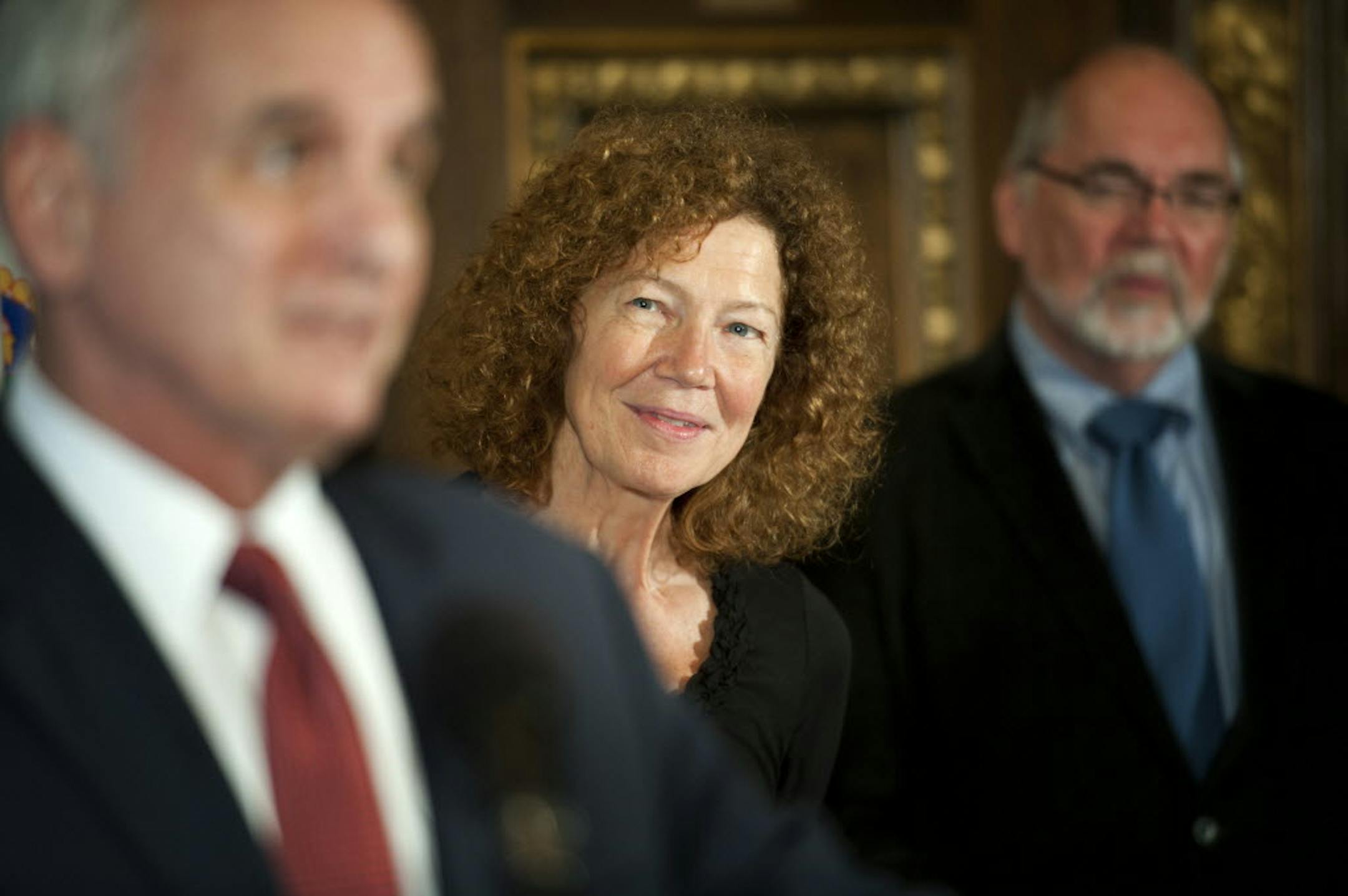 Joyce Sutphen listens as Gov. Mark Dayton recited his favorite poem from memory. At right is David O'Fallon, president and CEO of Minnesota Humanities Center.