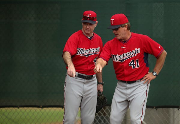Twins pitching coach Neil Allen (41) and manager Paul Molitor (4)