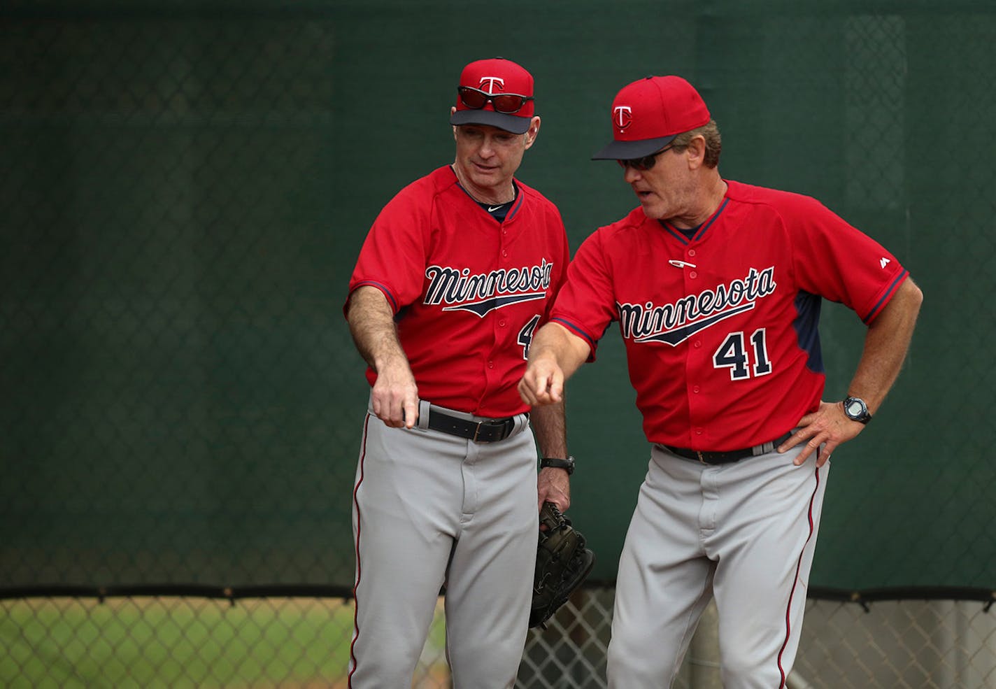 Twins pitching coach Neil Allen (41) and manager Paul Molitor (4)