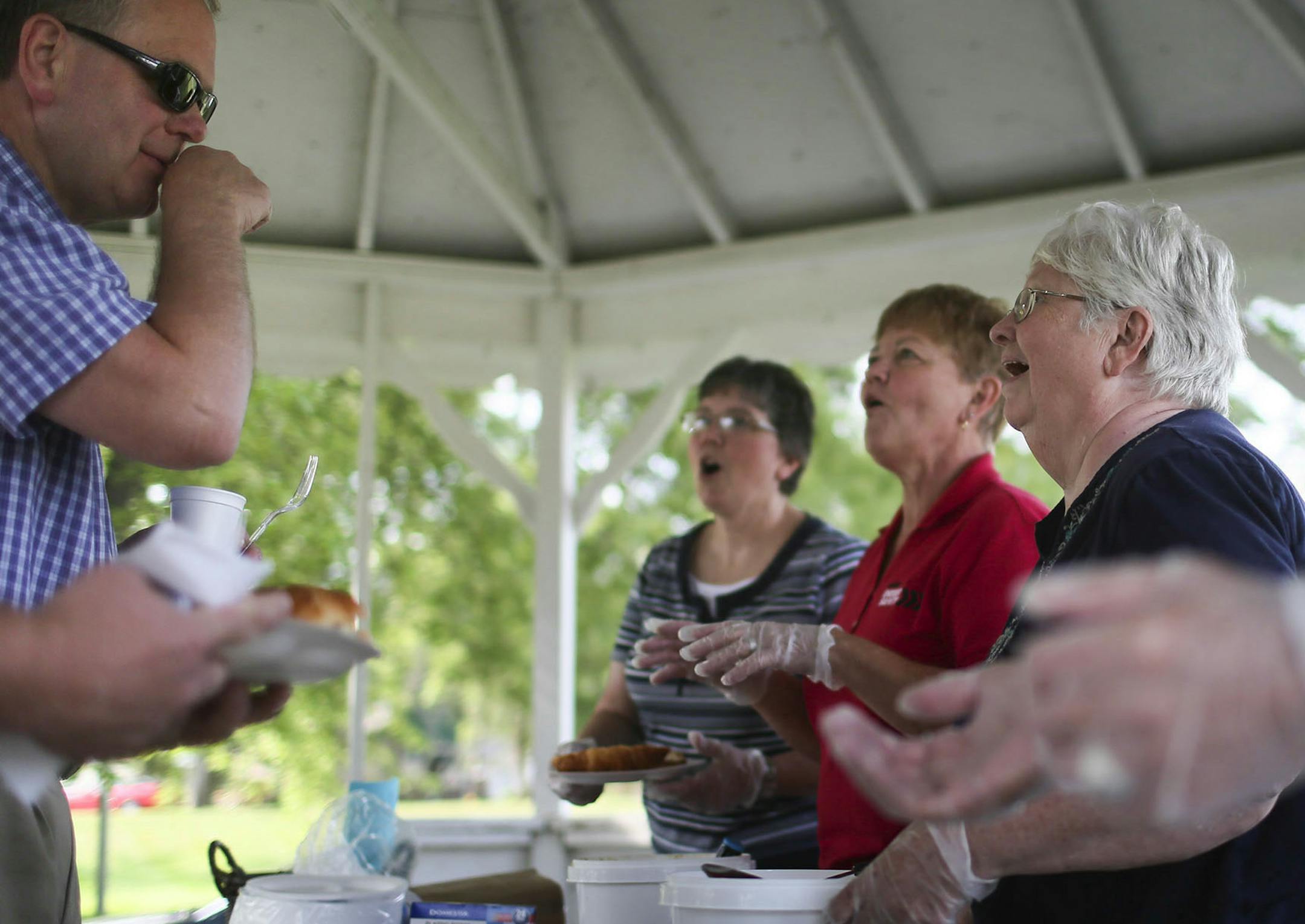 Hoffman town catalyst Muriel Krusemark, 73,second from left, helped served dinner at the weekly Hoffman flea market in the main town park Wednesday, July, 16, 2014, in Hoffman MN.] (DAVID JOLES/STARTRIBUNE) djoles@startribune When Muriel Krusemark, 73, moved back to her hometown of Hoffman, Minn., there were few open storefronts on Main Street. But since she became the part-time economic development director, each vacant space has been filled. It's a trick that many small towns across the Midwes