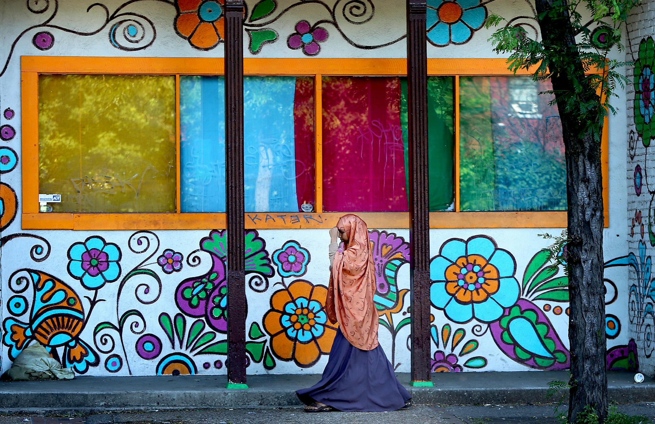Pedestrians made their way along Cedar Avenue, Thursday, June 27, 2013. Hennepin County has big plans for the historic Cedar-Riverside area. The county intends to tear up and narrow the road to two lanes to make way for expanding the sidewalks. The passage is the most highly traversed pedestrian area in Minneapolis and in 2014, it becomes even more of a crossroads with the opening of the new light-rail line between the Twin Cities. (ELIZABETH FLORES/STAR TRIBUNE) ELIZABETH FLORES ‚Ä&