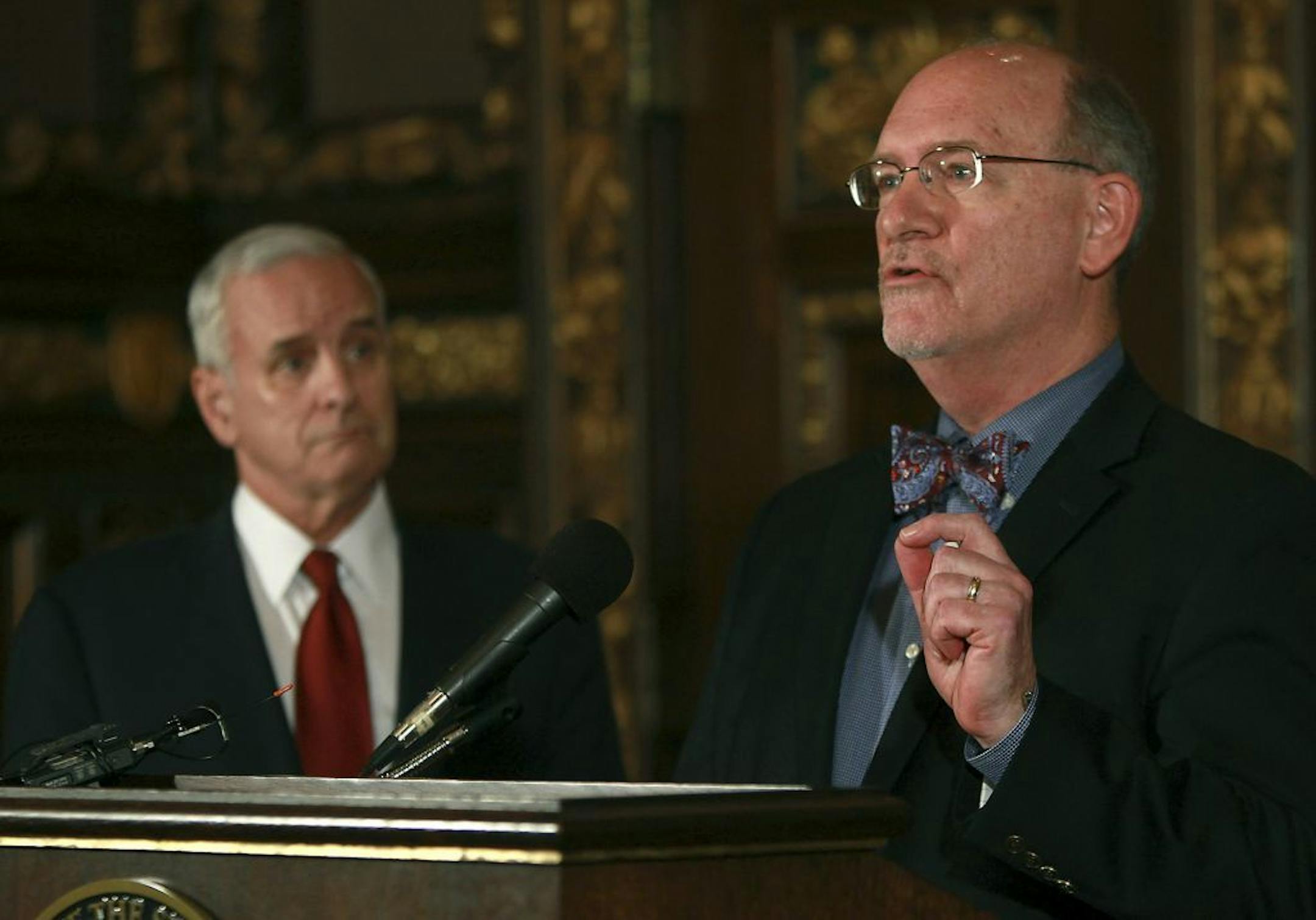 Governor Mark Dayton, left, and MN Department of Health Commissioner Ed Ehlinger showed their frustrations on how Assistant Majority Leader David W. Hann unilaterally blocked the use of nearly $25 million of federal funds to help thousands of sick, disabled, and elderly people throughout Minnesota. Part of the funding would connect 5,000 cancer-afflicted Minnessota childlren and their parents to potentially life-savinng research. Governor Dayton also expressed his frustrations regarding the Viki
