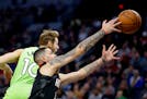 Houston Rockets guard Austin Rivers and Minnesota Timberwolves forward Jake Layman (10) in the first quarter during an NBA basketball game Saturday, N