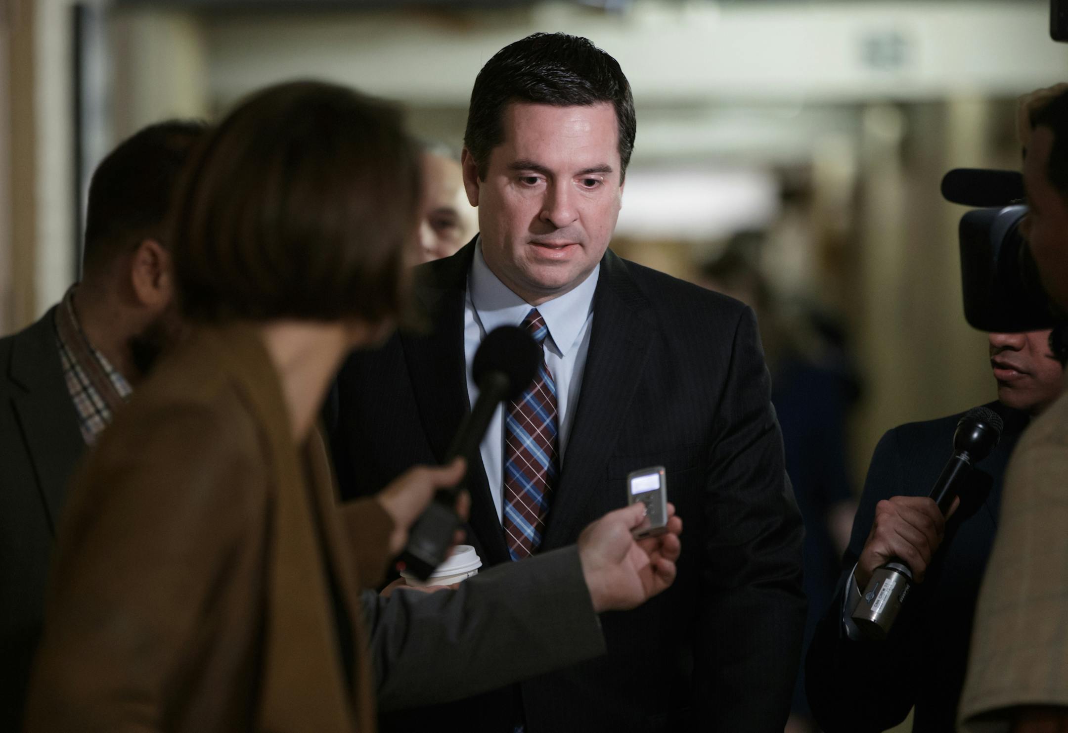 FILE - In this March 28, 2017 file photo, House Intelligence Committee Chairman Rep. Devin Nunes, R-Calif. is pursued by reporters on Capitol Hill in Washington. Nunes says he’s temporarily stepping aside from Russia probe amid ethics accusations. (AP Photo/J. Scott Applewhite, File)
