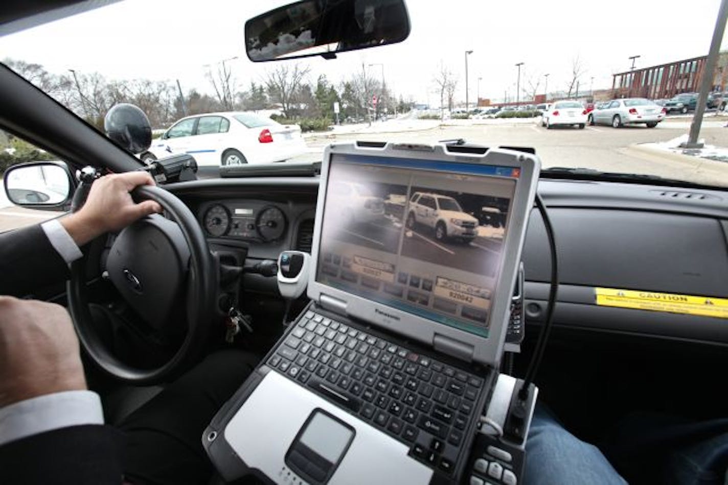 Bloomington detective Tim Brosam drove through the city parking lot with Automated License Plate Recognition cameras, which can scan thousands of plates per shift.