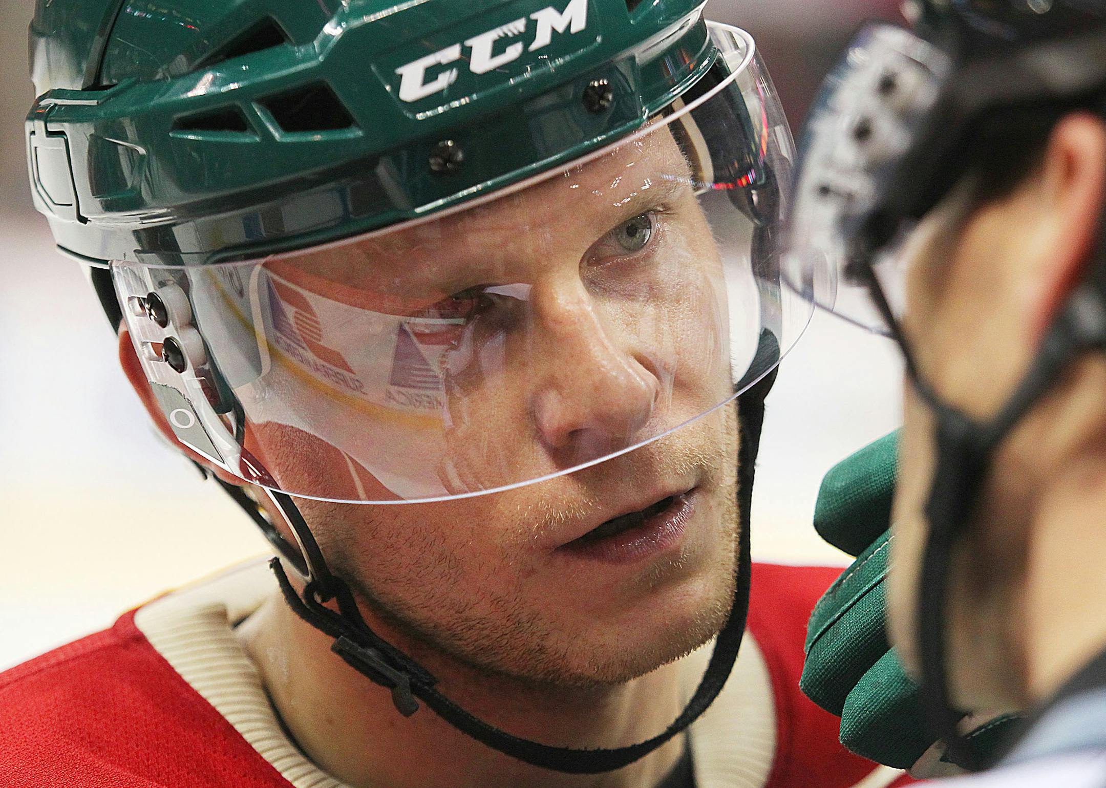 Minnesota Wild forward Mikko Koivu, left, talks with a referee in the third period against the New York Islanders during their NHL hockey game won by the Islanders 5-4, Sunday, Dec. 29, 2013, in St. Paul, Minn. (AP Photo/Andy Clayton-King) ORG XMIT: MNAK114
