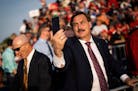 MyPillow chief executive Mike Lindell snaps a photo at a rally for former president Donald Trump in Ohio in June. In an interview this week, Lindell s