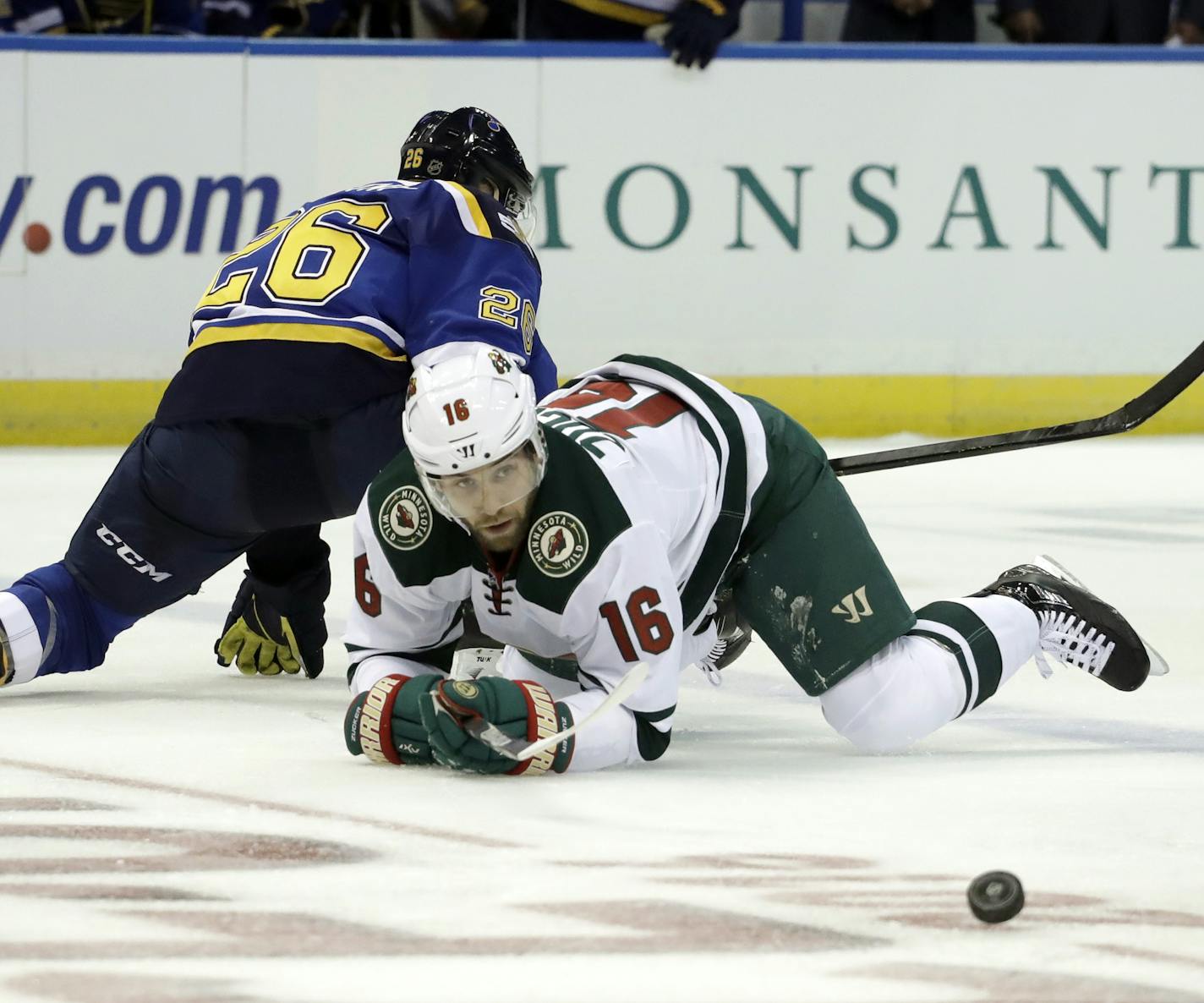 Minnesota Wild's Jason Zucker (16) falls as he collides with St. Louis Blues's Paul Stastny during the second period of an NHL hockey game Thursday, Oct. 13, 2016, in St. Louis. (AP Photo/Jeff Roberson)