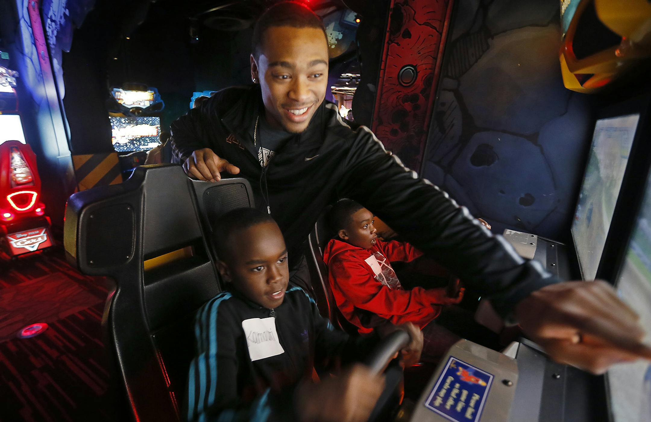 Minnesota's Cedric Thompson played video games with kids that he was matched up with for play at Disney World's Disney Quest, December 27, 2014 in Orlando, FL. Minnesota players joined players from Missouri and special needs and underprivileged kids for a morning of play at the multi-story arcade. ] (ELIZABETH FLORES/STAR TRIBUNE) ELIZABETH FLORES • eflores@startribune.com ORG XMIT: MIN1412271120191345
