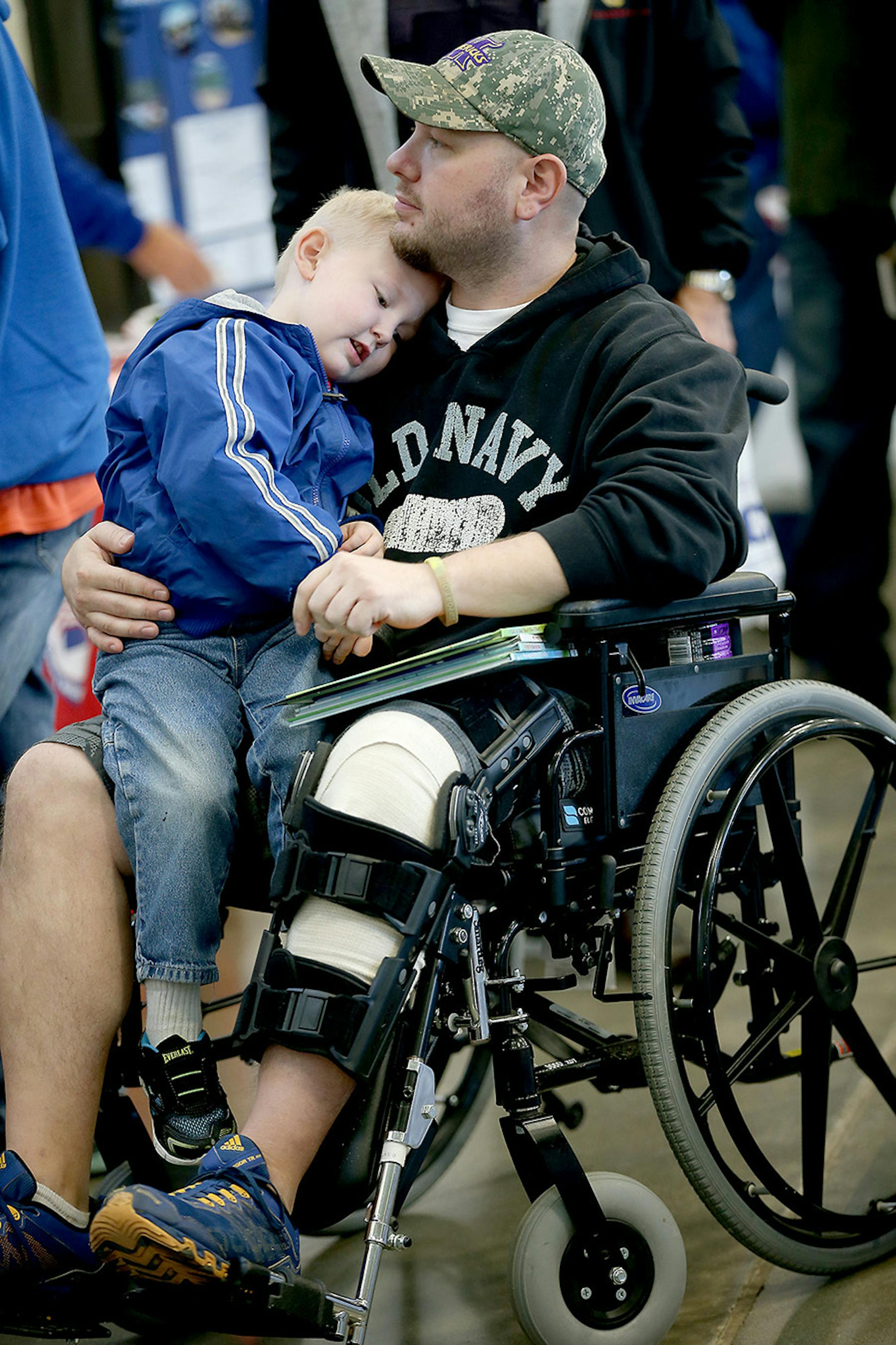 Joseph Peterson of St. Peter, held his son Jacob, 3, on his lap as they received medical information from one of the vendors at the Standdown for Veterans event at the Mankato National Guard Armory, Tuesday, November 10, 2015 in Mankato, MN. Veterans were given free services like meals, clothing, eye glasses, haircut vouchers, legal aid, and a host of other things. Peterson received a medically honorable discharge from the Army.