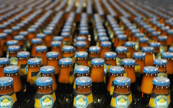 Bottles of India Pale Ale move down the production line at Summit Brewing Co. of St. Paul.