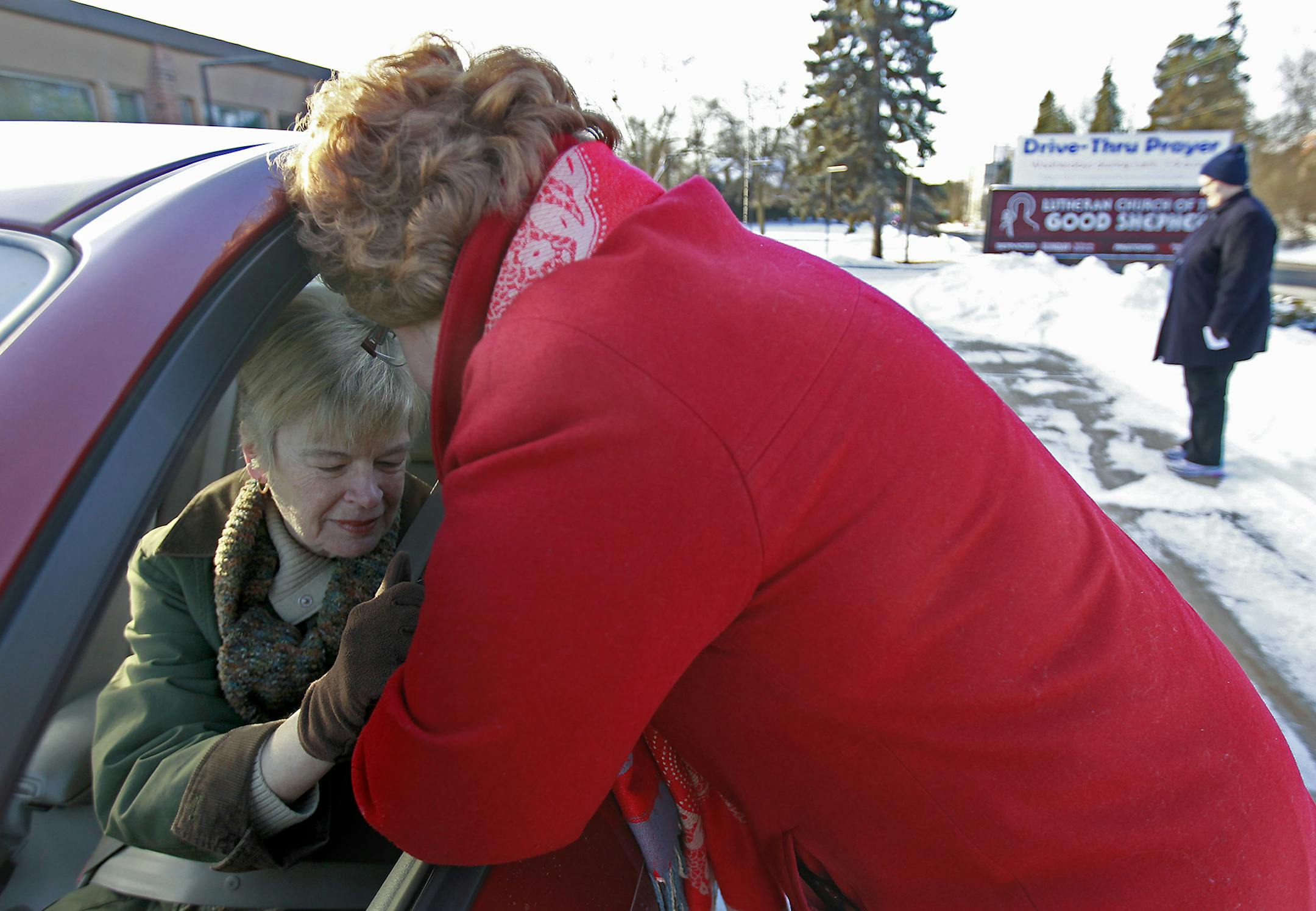 Church Outreach Minister Karen Walhot prayed with Joy Erickson and other passengers as they made their way through the Lutheran Church of the Good Shepherd parking lot, Wednesday, March 4, 2015 in Minneapolis, MN. T ] (ELIZABETH FLORES/STAR TRIBUNE) ELIZABETH FLORES • eflores@startribune.com