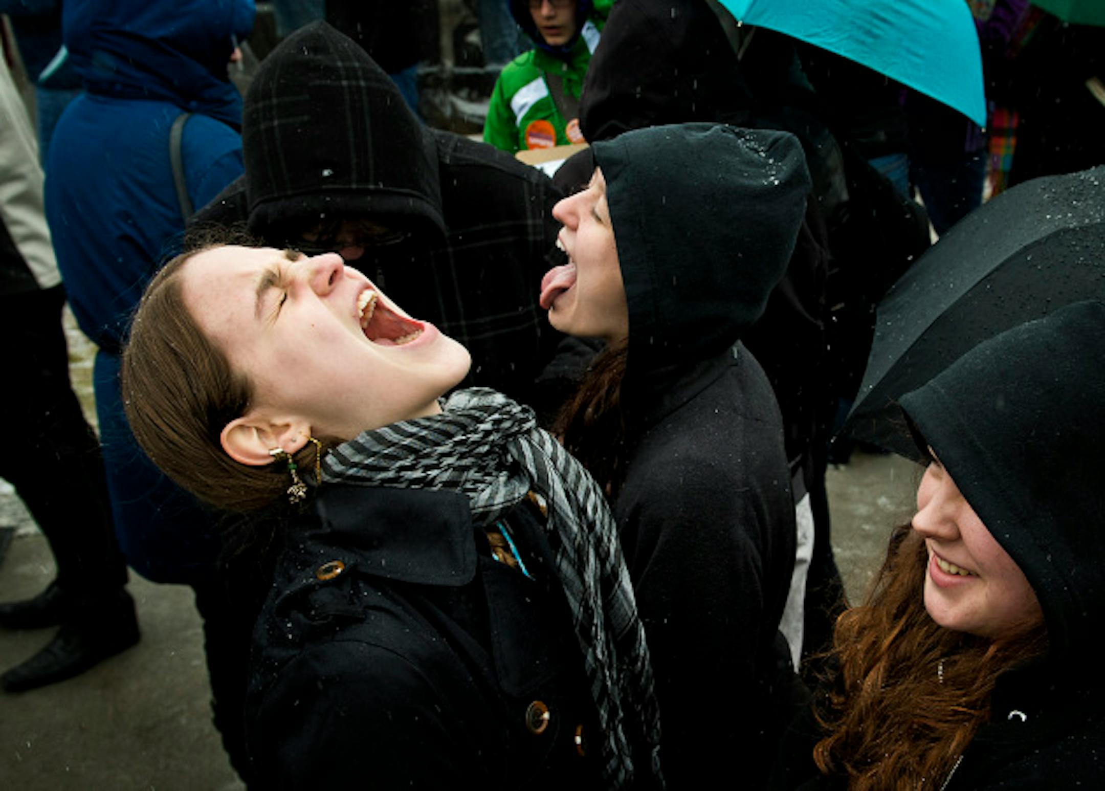 Lian Simmer and Calla Paule tried to catch sleet and freezing rain in their mouths before the rally started in front of the Capitol.   Hundreds of Minnesotans from around the state rallied in front of the State Capitol in support of same-sex couples to be allowed to marry.  Key bills are expected soon at the legislature.  Thursday, April 18, 2013     ]     GLEN STUBBE * gstubbe@startribune.com