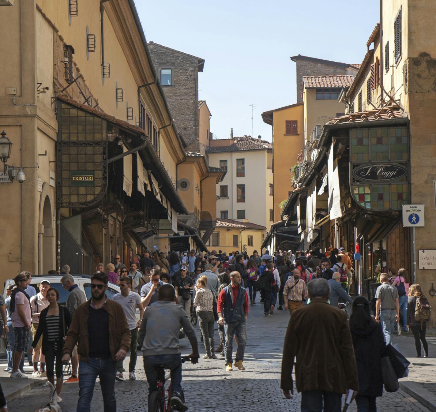 iStock Photo of Florence, Italy - April 22, 2015: view on Pont Vecchio from the old town (Via Por Santa Maria). The bridge and its shops attracts hundreds of visitors.