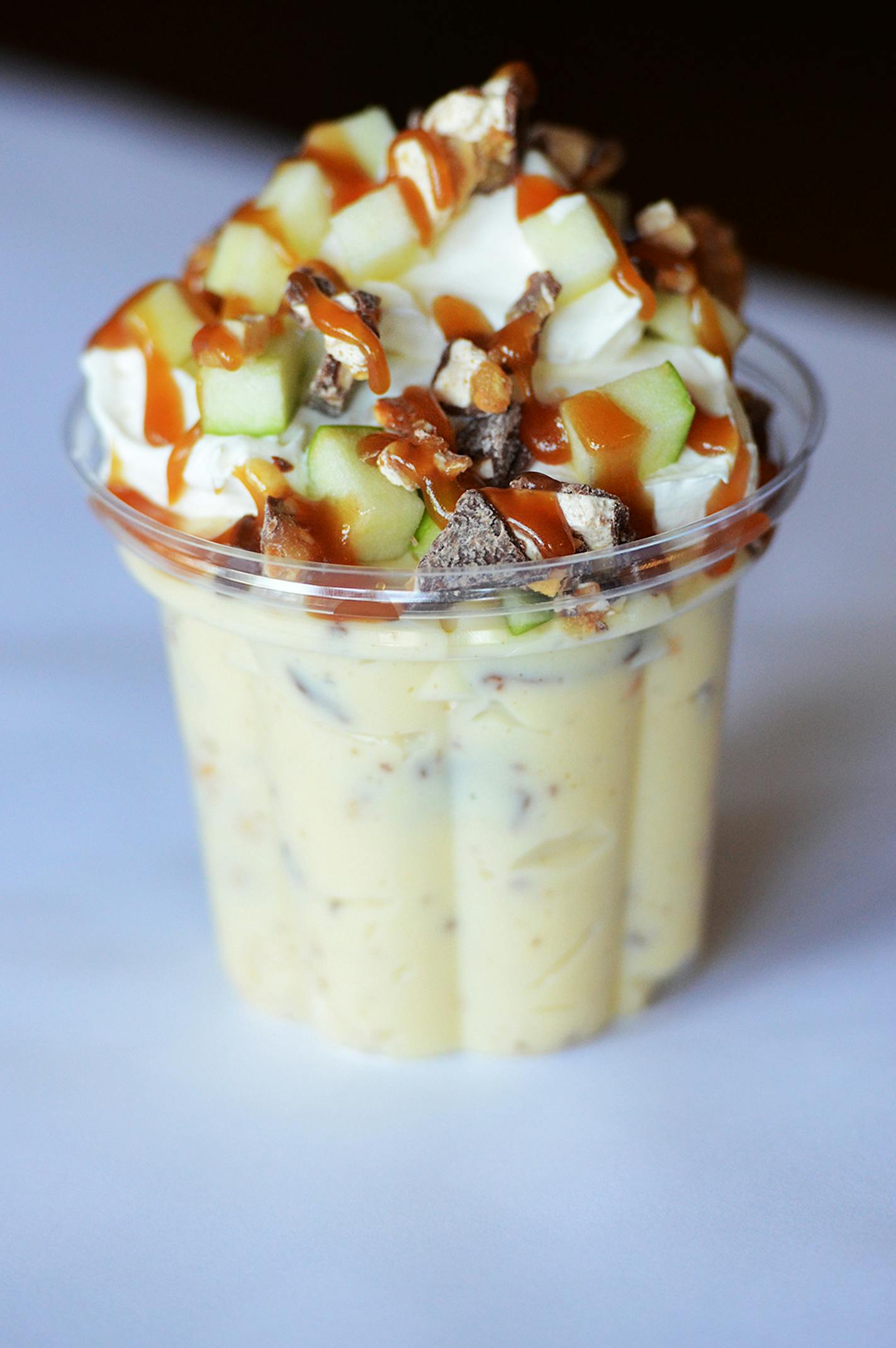 Grandma Deb's Snicker Bar Salad: Chopped Snickers® bars and Granny Smith apples tossed in vanilla pudding with whipped cream and drizzled with caramel sauce. Find it at The Blue Barn located at West End Market, east side, south of the History & Heritage Center.