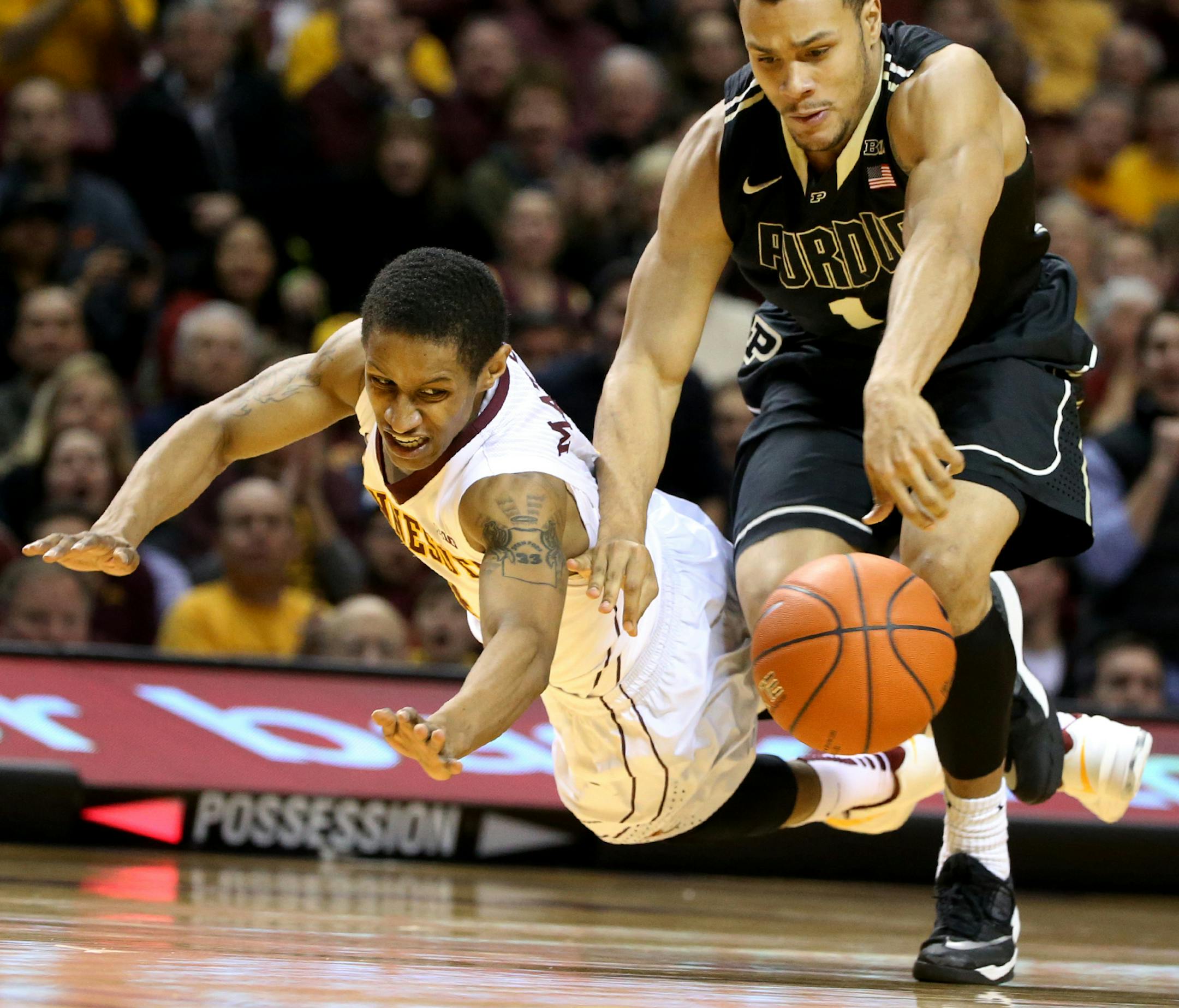 University of Minnesota's DeAndre Mathieu flies to the floor while attempting a steal against Purdue 's Bryson Scott (1) during the second half of the Gophers 62-58 win Saturday, Feb. 7, 2015, at Williams Arena in Minneapolis, MN.](DAVID JOLES/STARTRIBUNE)djoles@startribune.com University of Minnesota versus Purdue Saturday, Feb. 7, 2015, at Williams Arena in Minneapolis, MN.