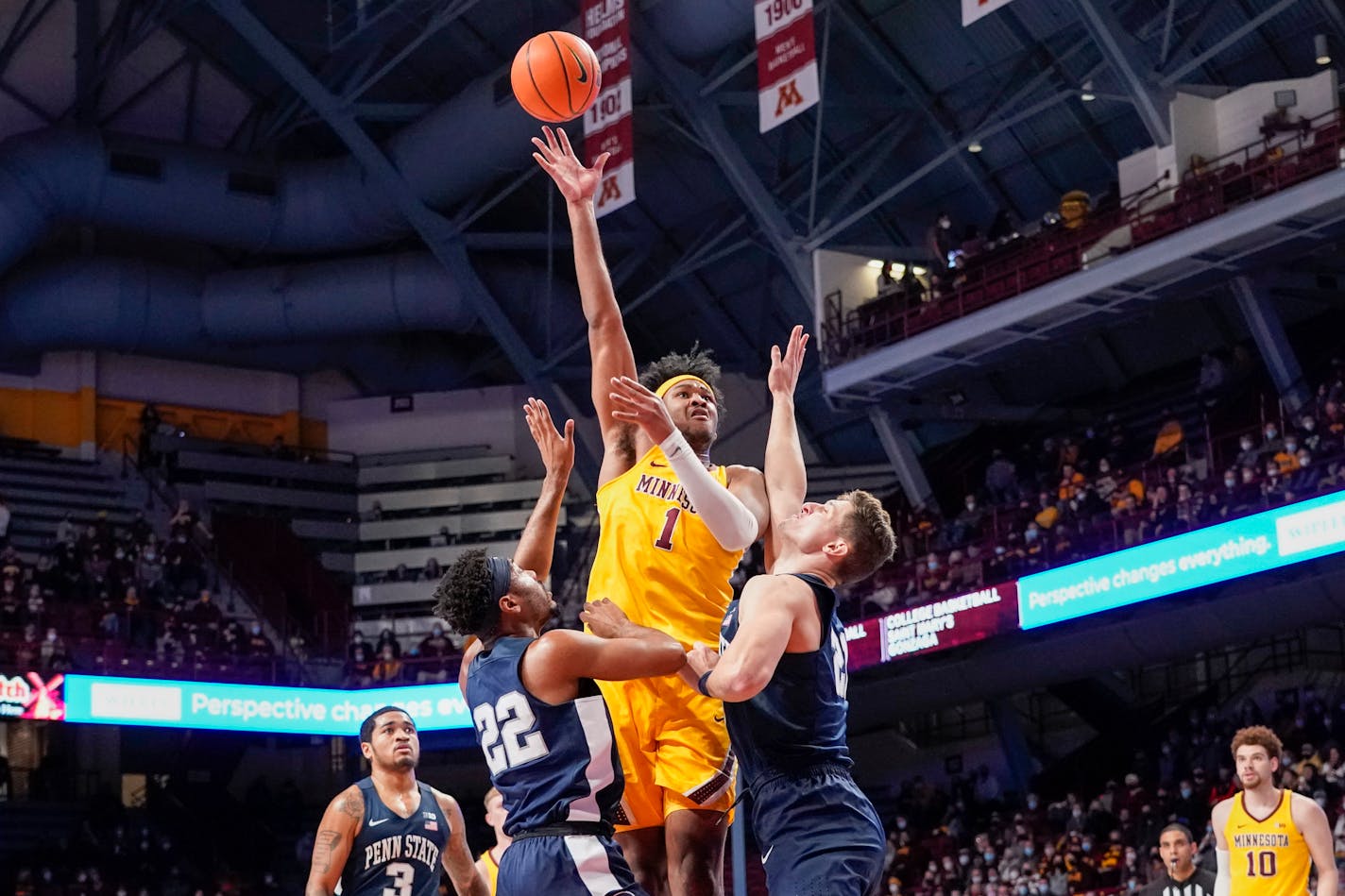 Gophers forward Eric Curry takes a shot over Penn State guard Jalen Pickett and forward John Harrar during the first half Saturday