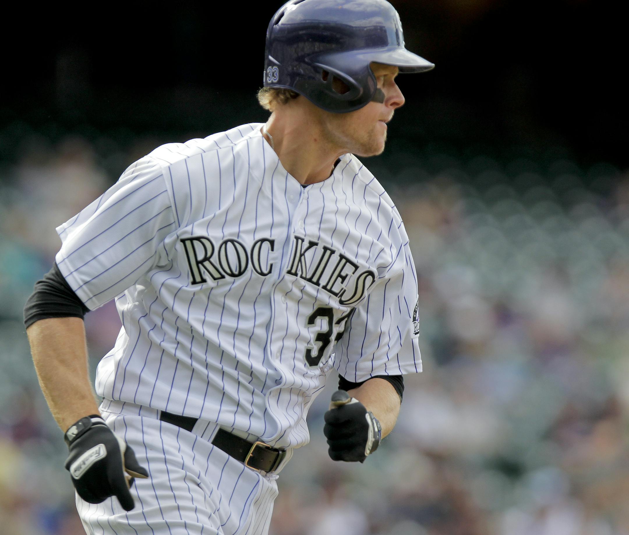 Colorado Rockies' Justin Morneau singles during the eighth inning of a baseball game against the Chicago White Sox, Wednesday, April 9, 2014, in Denver. The Rockies won 10-4. (AP Photo/Barry Gutierrez) ORG XMIT: COBG110
