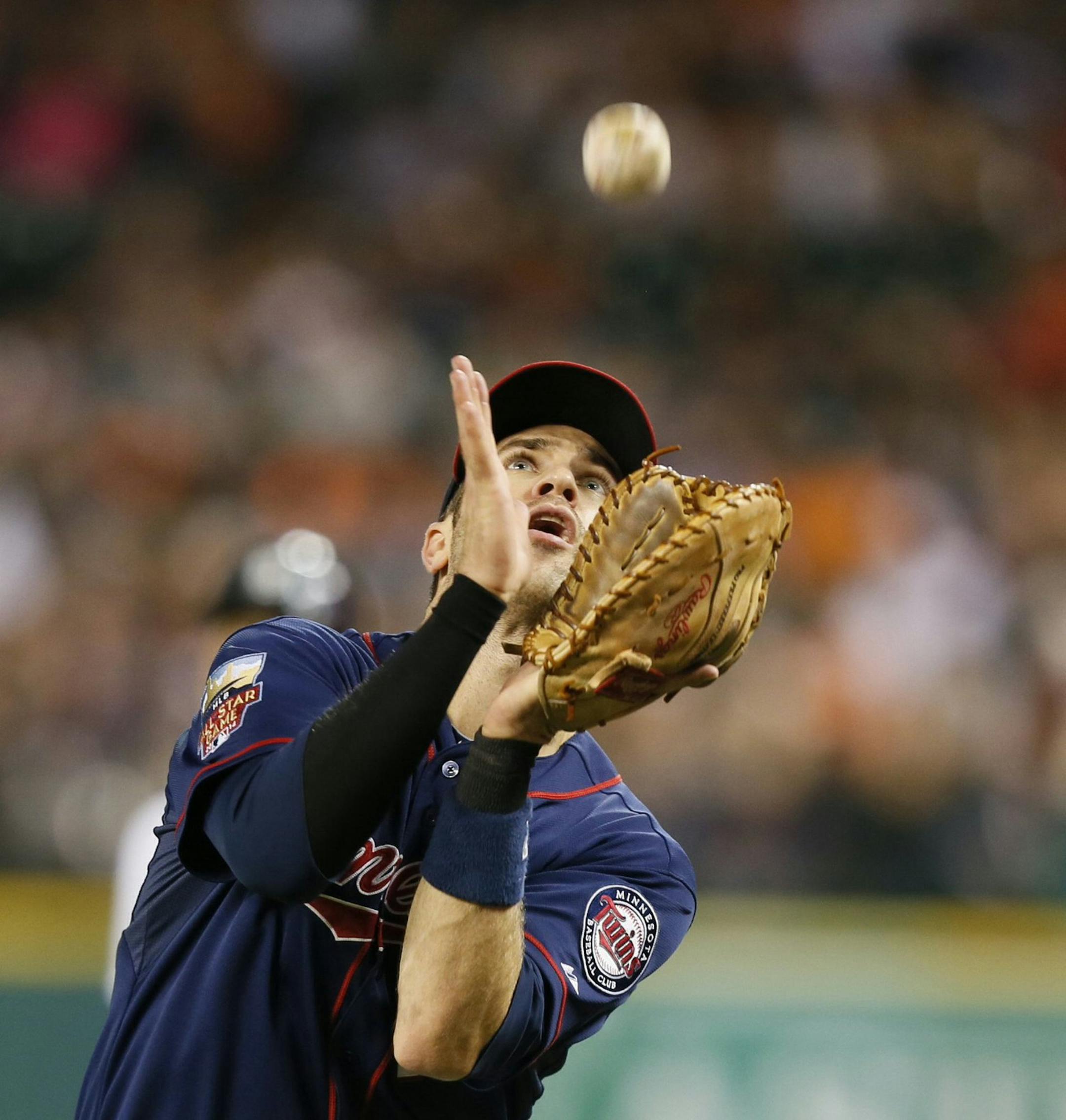 Minnesota Twins first baseman Joe Mauer catches a foul pop-up to put out Detroit Tigers' Eugenio Suarez during the fifth inning on Thursday, Sept. 25, 2014, at Comerica Park in Detroit. (Julian H. Gonzalez/Detroit Free Press/MCT)