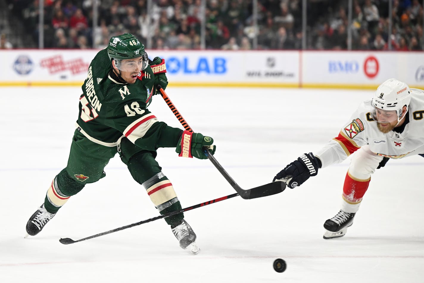 Minnesota Wild defenseman Jared Spurgeon (46) attempts a shot as Florida Panthers center Sam Bennett reaches for poke check during the first period of an NHL hockey game Monday, Feb. 13, 2023 at the Xcel Energy Center in St. Paul, Minn. ] AARON LAVINSKY • aaron.lavinsky@startribune.com