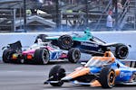 Marcus Ericsson (28) goes over the top of Tom Blomqvist as the collide in the first turn during the Indianapolis 500 on Sunday.