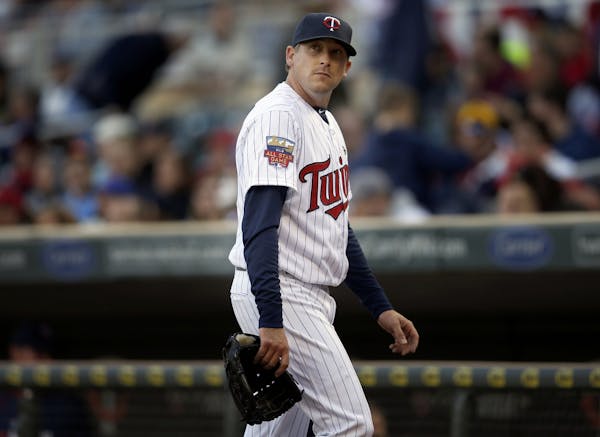 Minnesota Twins starting pitcher Kevin Correia (30) walked to the dugout after being pulled out of the game in the sixth inning.