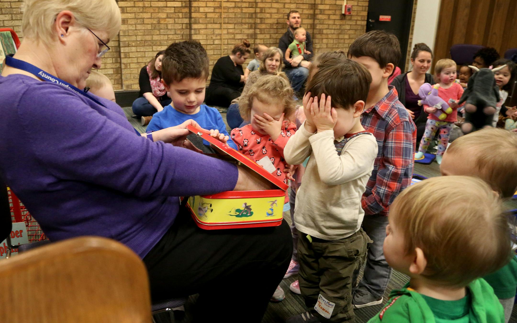 Near the end of her final reading time for young children and their parents, Anne Johnson, a librarian with the Hennepin County system, employed there for 49 years, asked children to close their eyes before revealing to them plastic letters and a book she hid in a curious George lunch box at the Hennepin County Library at 8800 Penn Ave. S.Tuesday, Feb. 28, 2017, in Bloomington, MN. In retirement Johnson plans to clean her house, exercise more, garden and spend more time with family and friends.