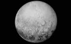 This July 11, 2015, image provided by NASA shows Pluto from the New Horizons spacecraft. On Tuesday, July 14, NASA's New Horizons spacecraft will come
