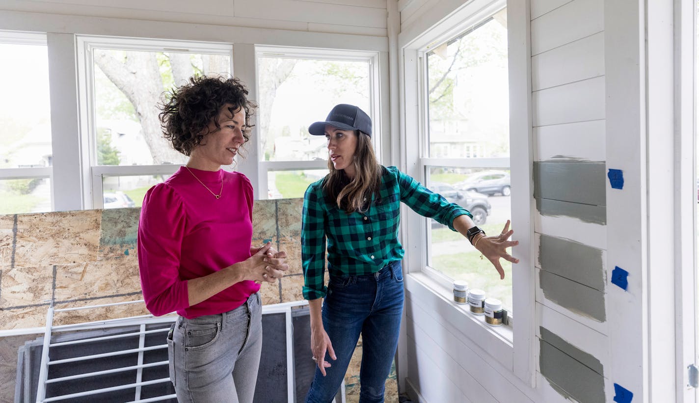 Hosts Lindsey Uselding and Kirsten Meehan decide on paint colors in the porch of a Minneapolis home, as seen on Renovation 911.