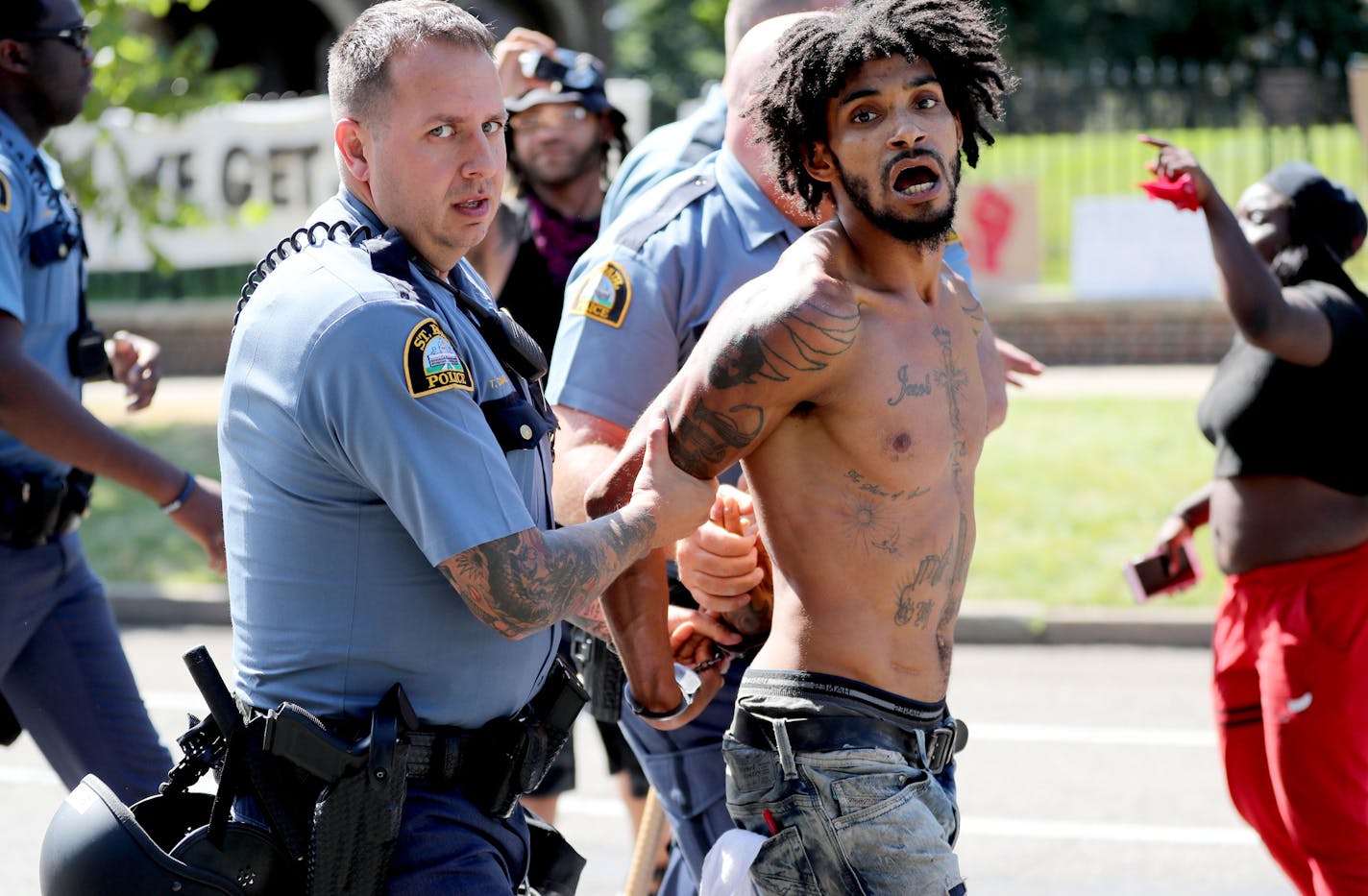 After St. Paul police officers moved in on protestors one of the movements leaders Jacob Ladda is taken away in handcuffs Tuesday, July 26, 2016, in front of Gov. Mark Dayton's mansion in St. Paul, MN.](DAVID JOLES/STARTRIBUNE)djoles@startribune Protesters were ordered Tuesday to clear the street and sidewalk in front of the governor's residence, where they have been since the fatal police shooting of Philando Castile nearly three weeks ago in neighboring Falcon Heights.**Wesley Martin,,cq