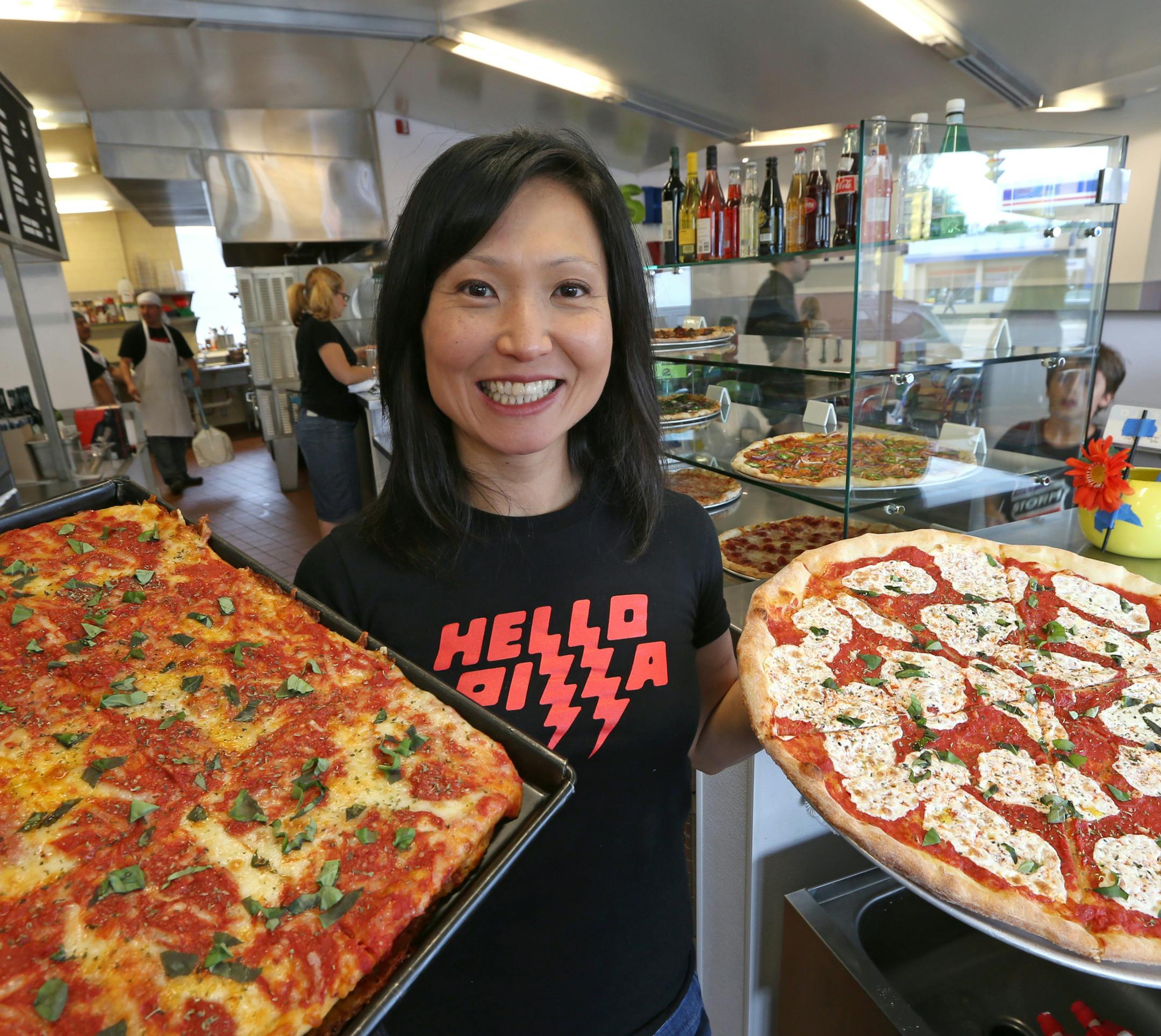 Ann Kim, owner of Hello Pizza in Edina, held a Sicilian pan pie and a Hello Rita pizza, as she was photographed on 6/28/13.] Bruce Bisping/Star Tribune.com bbisping@startribune.com Ann Kim/roster.