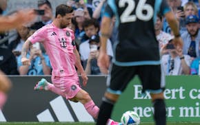 Inter Miami forward Lionel Messi crosses the ball against Minnesota United in the first half Saturday at Allianz Field.