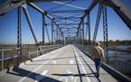 Marty Becker went for a walk to watch the birds in the water on the old Cedar Avenue bridge on Thursday, October 13, 2016, in Bloomington, Minn. Becke