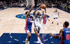 The Timberwolves' Naz Reid attempts a shot in the first half.